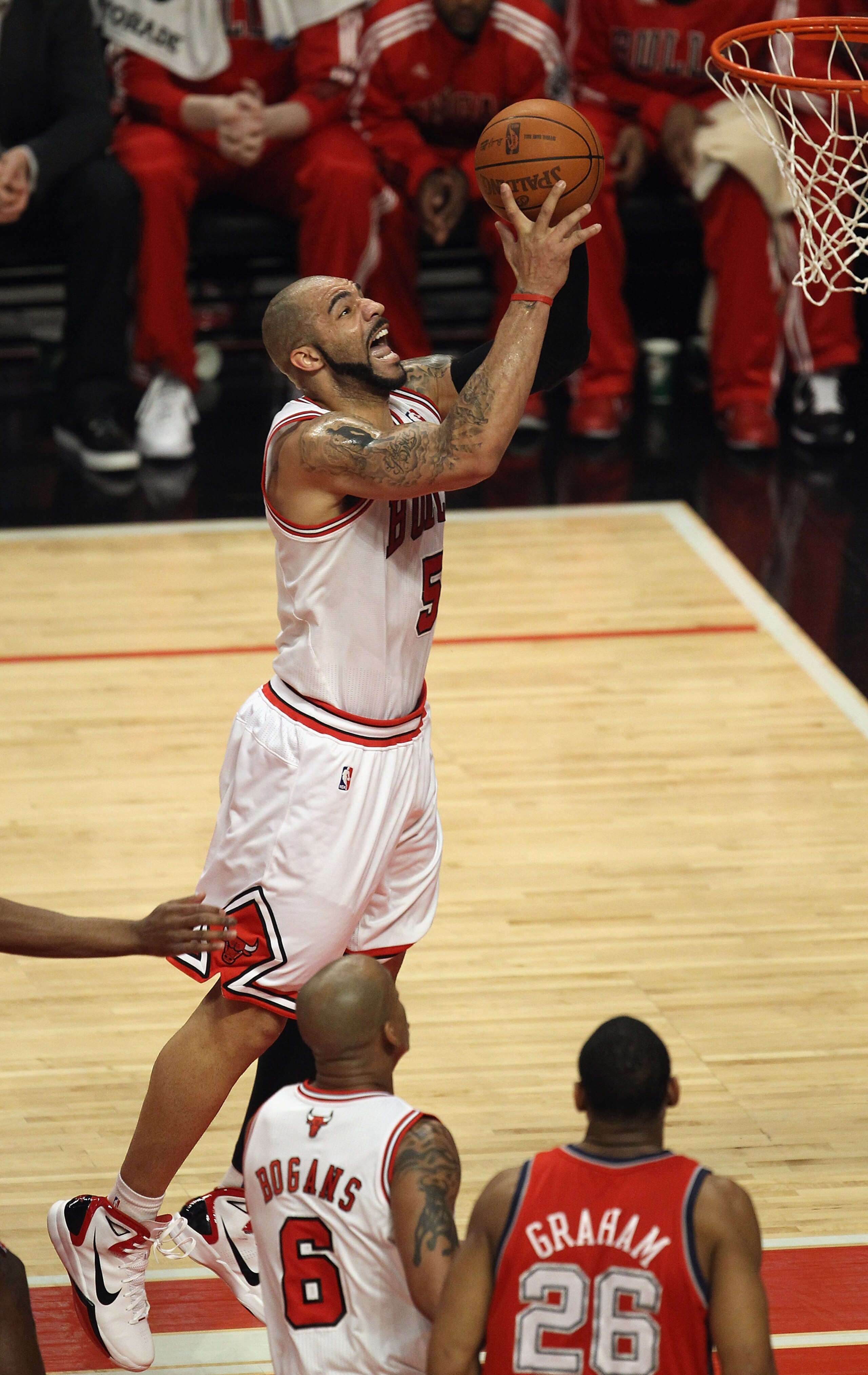 CHICAGO, IL - APRIL 13: Carlos Boozer #5 of the Chicago Bulls puts up a shot against the New Jersey Nets at the United Center on April 13, 2011 in Chicago, Illinois. The Bulls defeated the Nets 97-92. NOTE TO USER: User expressly acknowledges and agress t