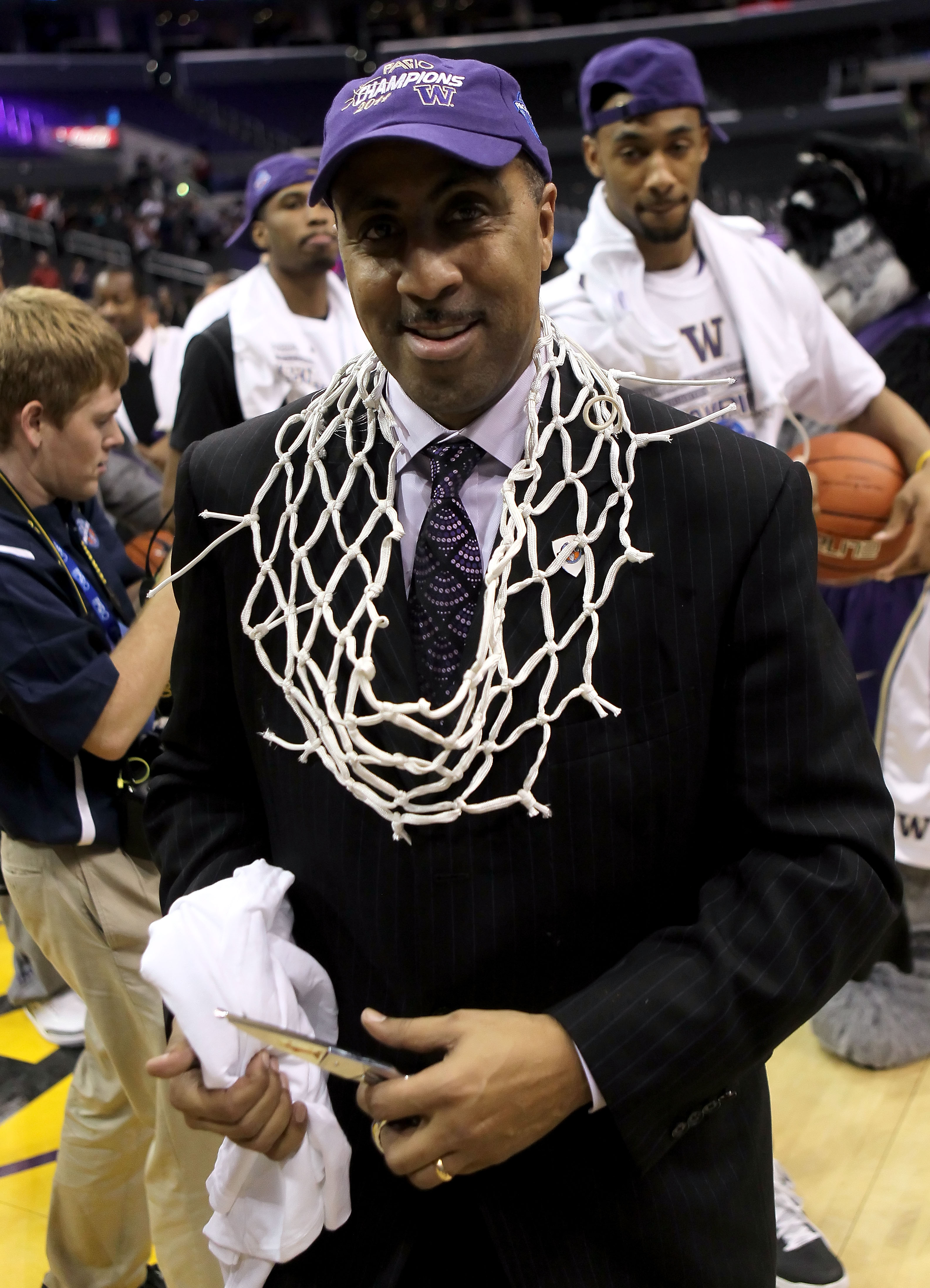 LOS ANGELES, CA - MARCH 12:  Head coach Lorenzo Romar of the Washington Huskies celebrates with the net after the Huskies defeated the Arizona Wildcats 77-75 in the championship game of the 2011 Pacific Life Pac-10 Men's Basketball Tournament at Staples C
