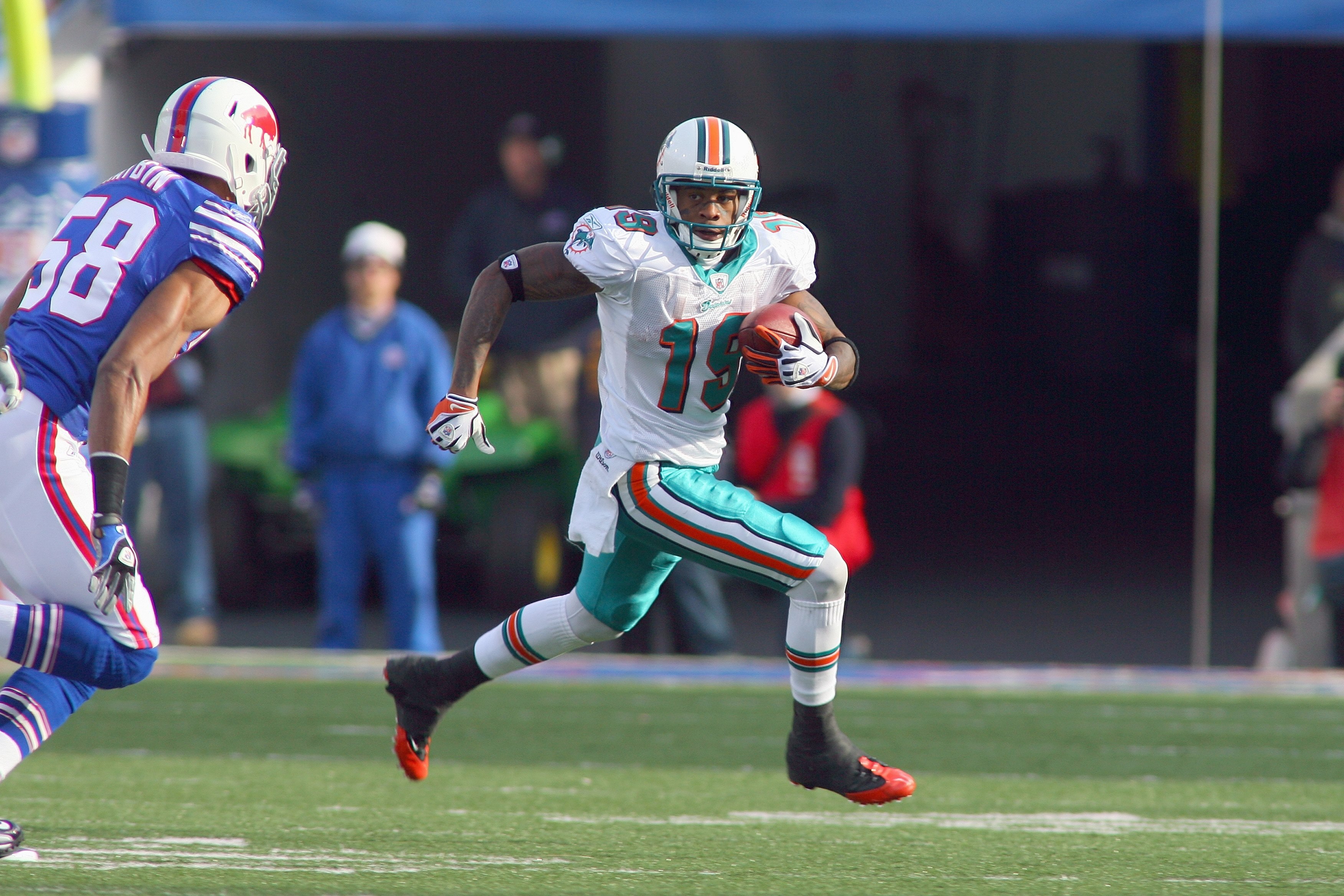 ORCHARD PARK, NY - NOVEMBER 29: Ted Ginn Jr. #19 of the Miami Dolphins carries the ball during the game against the Buffalo Bills at Ralph Wilson Stadium on November 29, 2009 in Orchard Park, New York. Buffalo won 31-14. (Photo by Rick Stewart/Getty Imag ORCHARD PARK, NY - NOVEMBER 29: Ted Ginn Jr. #19 of the Miami Dolphins carries the ball during the game against the Buffalo Bills at Ralph Wilson Stadium on November 29, 2009 in Orchard Park, New York. Buffalo won 31-14. (Photo by Rick Stewart/Getty Imag