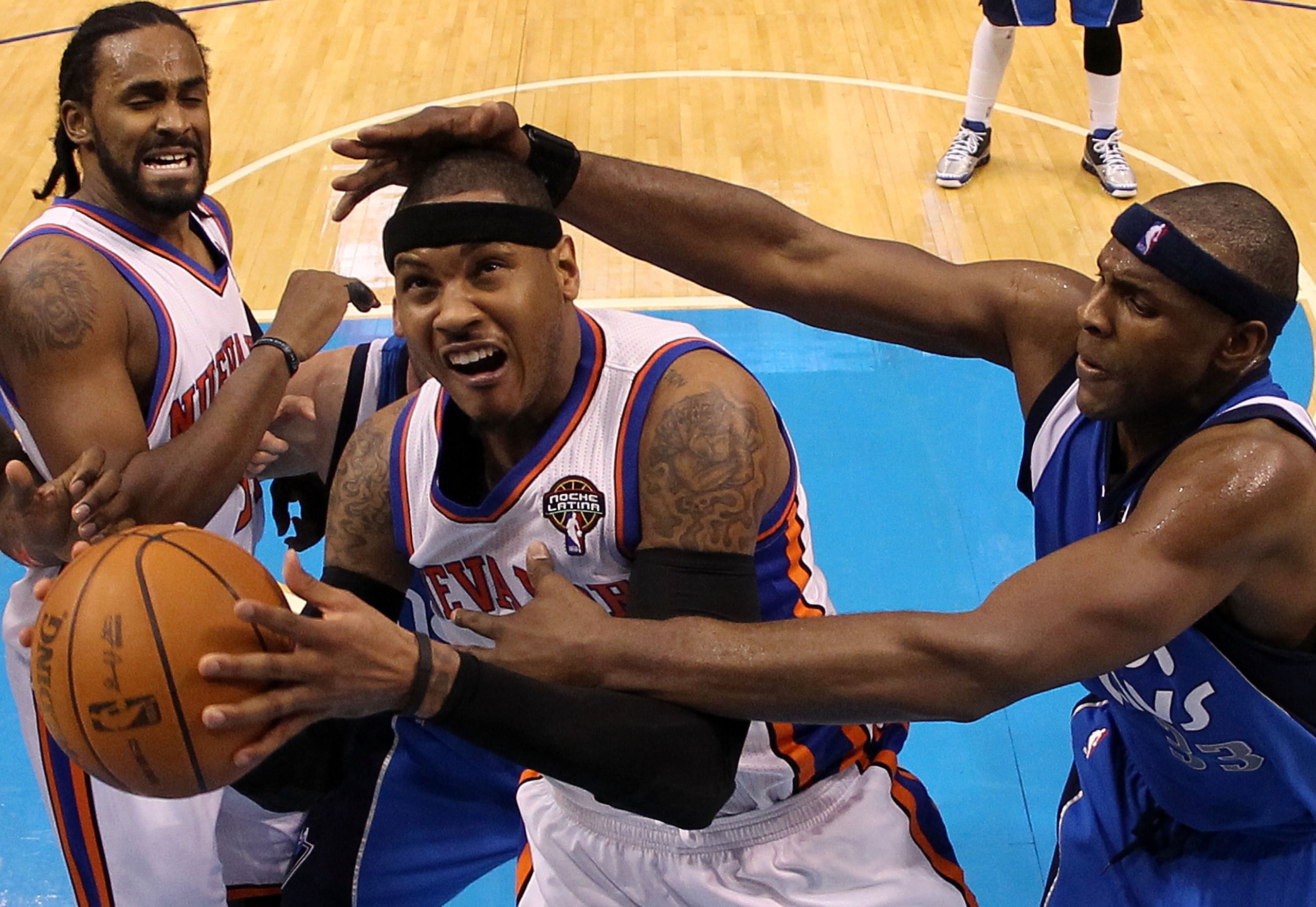 DALLAS, TX - MARCH 10:  Forward Carmelo Anthony #7 of the New York Knicks is fouled by Brendan Haywood #33 of the Dallas Mavericks at American Airlines Center on March 10, 2011 in Dallas, Texas.  NOTE TO USER: User expressly acknowledges and agrees that,