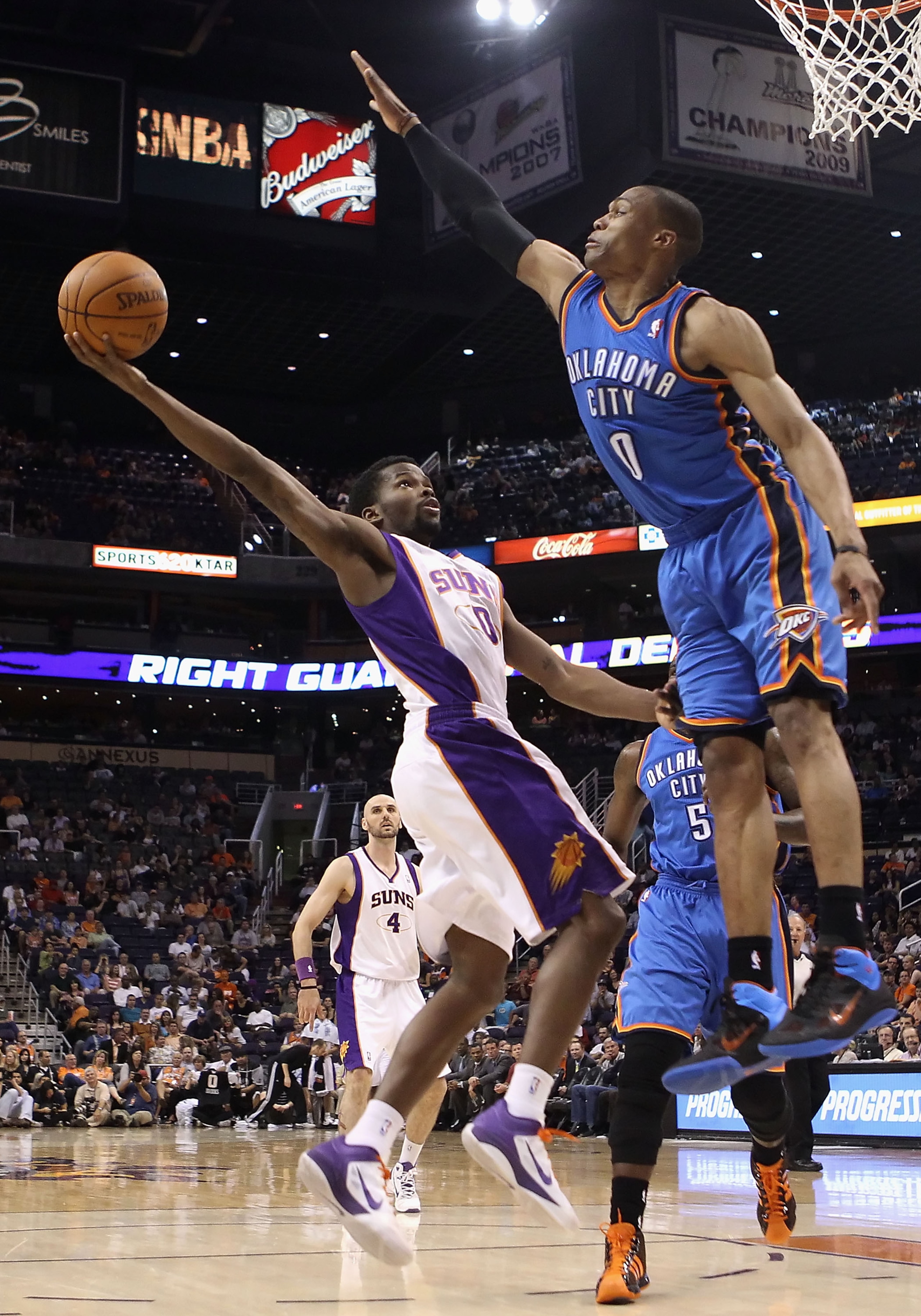 PHOENIX, AZ - MARCH 30:  Aaron Brooks #0 of the Phoenix Suns puts up a shot against Russell Westbrook #0 of the Oklahoma City Thunder during the NBA game at US Airways Center on March 30, 2011 in Phoenix, Arizona.  The Thunder defeated the Suns 116-98. NO