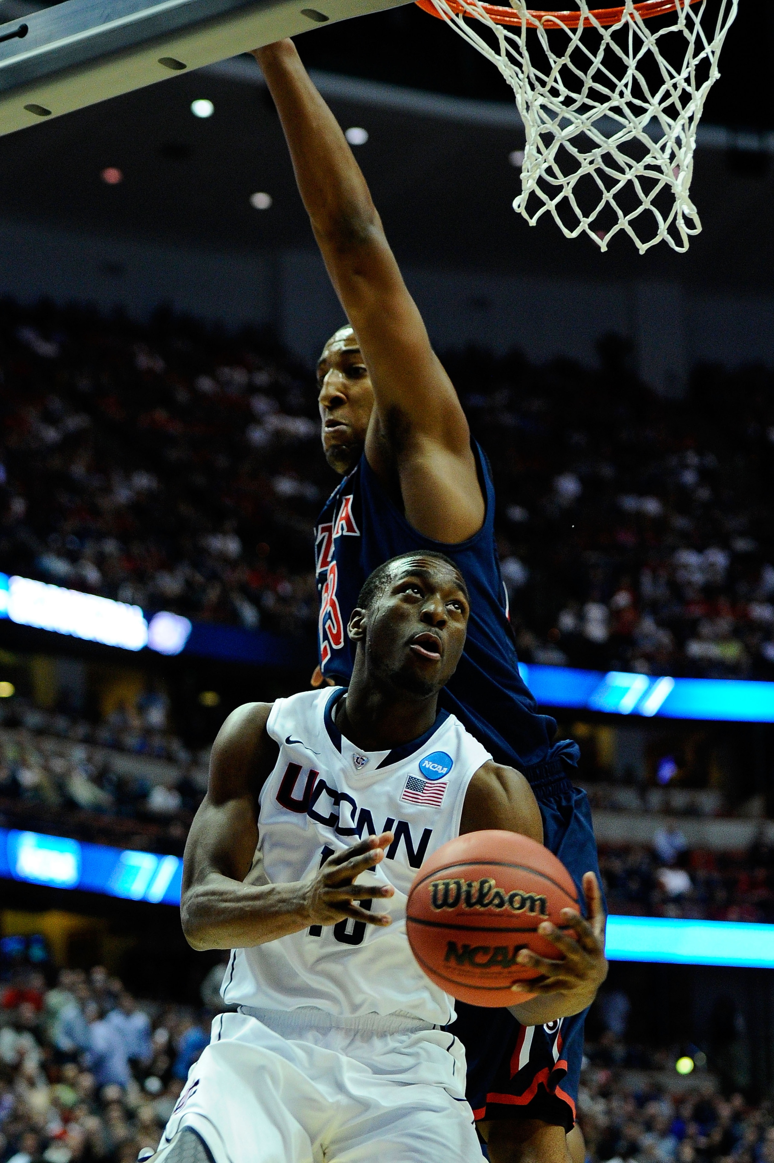 ANAHEIM, CA - MARCH 26:  Kemba Walker #15 of the Connecticut Huskies goes to the basket Derrick Williams #23 of the Arizona Wildcats during the west regional final of the 2011 NCAA men's basketball tournament at the Honda Center on March 26, 2011 in Anahe