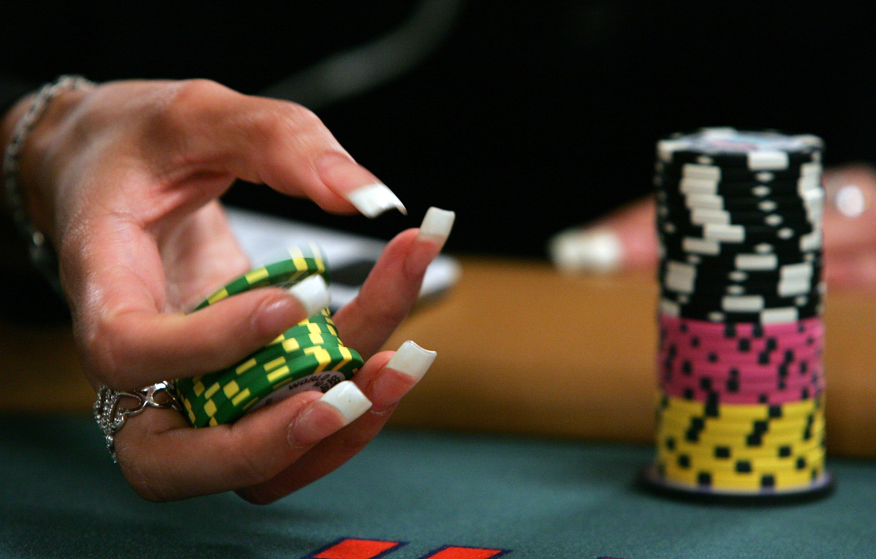 LAS VEGAS - JULY 30:  Poker player Liz Lieu plays with her chips as she competes on the third day of the first round of the World Series of Poker no-limit Texas Hold 'em main event at the Rio Hotel & Casino July 30, 2006 in Las Vegas, Nevada. More than 8,