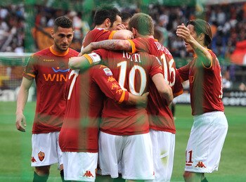 ROME, ITALY - APRIL 16:  Francesco Totti of Roma celebrates with mates after scoring the opening goal during the Serie A match between AS Roma and US Citta di Palermo at Stadio Olimpico on April 16, 2011 in Rome, Italy.  (Photo by Tullio M. Puglia/Getty I