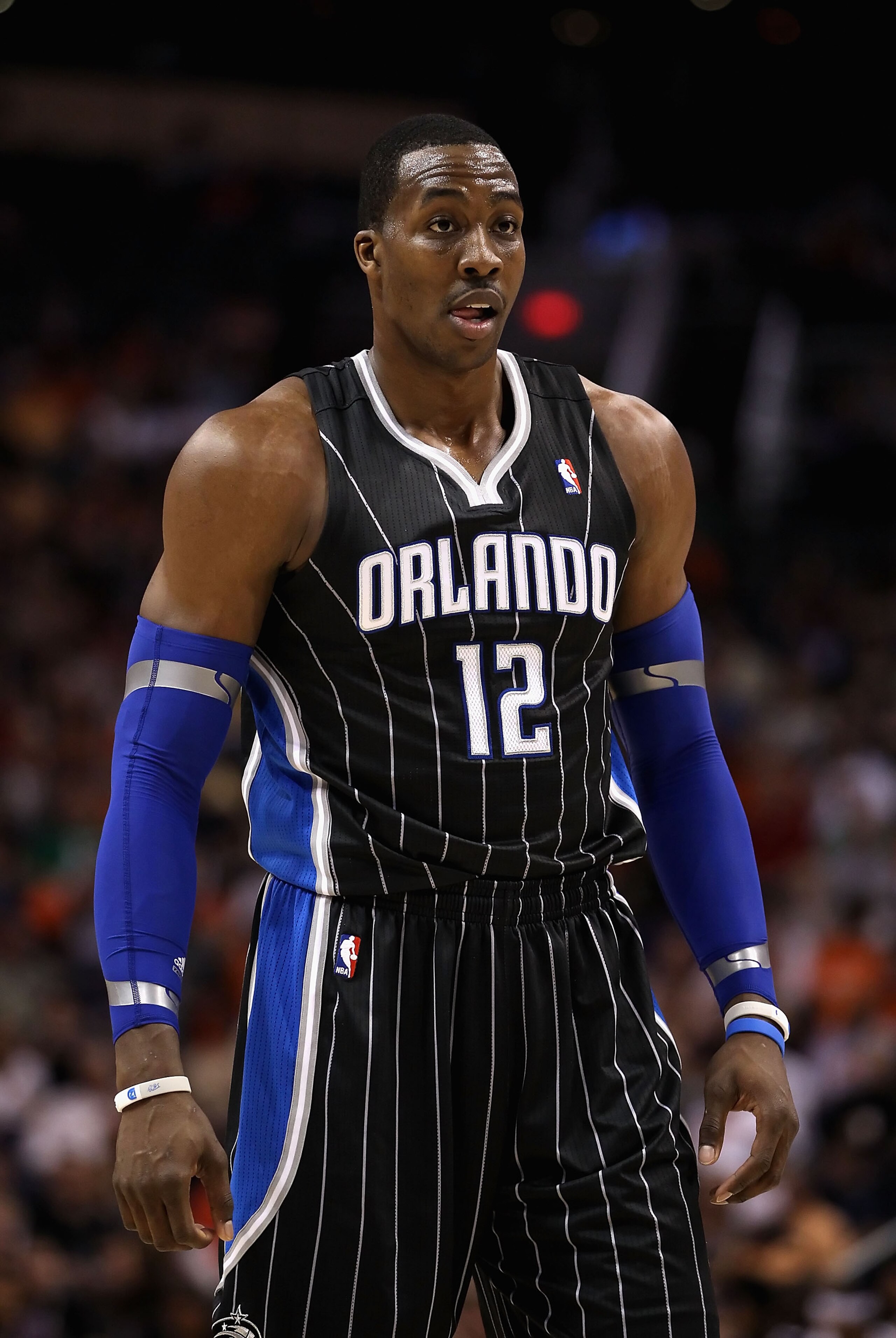 PHOENIX, AZ - MARCH 13: Dwight Howard #12 of the Orlando Magic during the NBA game against the Phoenix Suns at US Airways Center on March 13, 2011 in Phoenix, Arizona. The Magic defeated the Suns 111-88. NOTE TO USER: User expressly acknowledges and agre PHOENIX, AZ - MARCH 13: Dwight Howard #12 of the Orlando Magic during the NBA game against the Phoenix Suns at US Airways Center on March 13, 2011 in Phoenix, Arizona. The Magic defeated the Suns 111-88. NOTE TO USER: User expressly acknowledges and agre