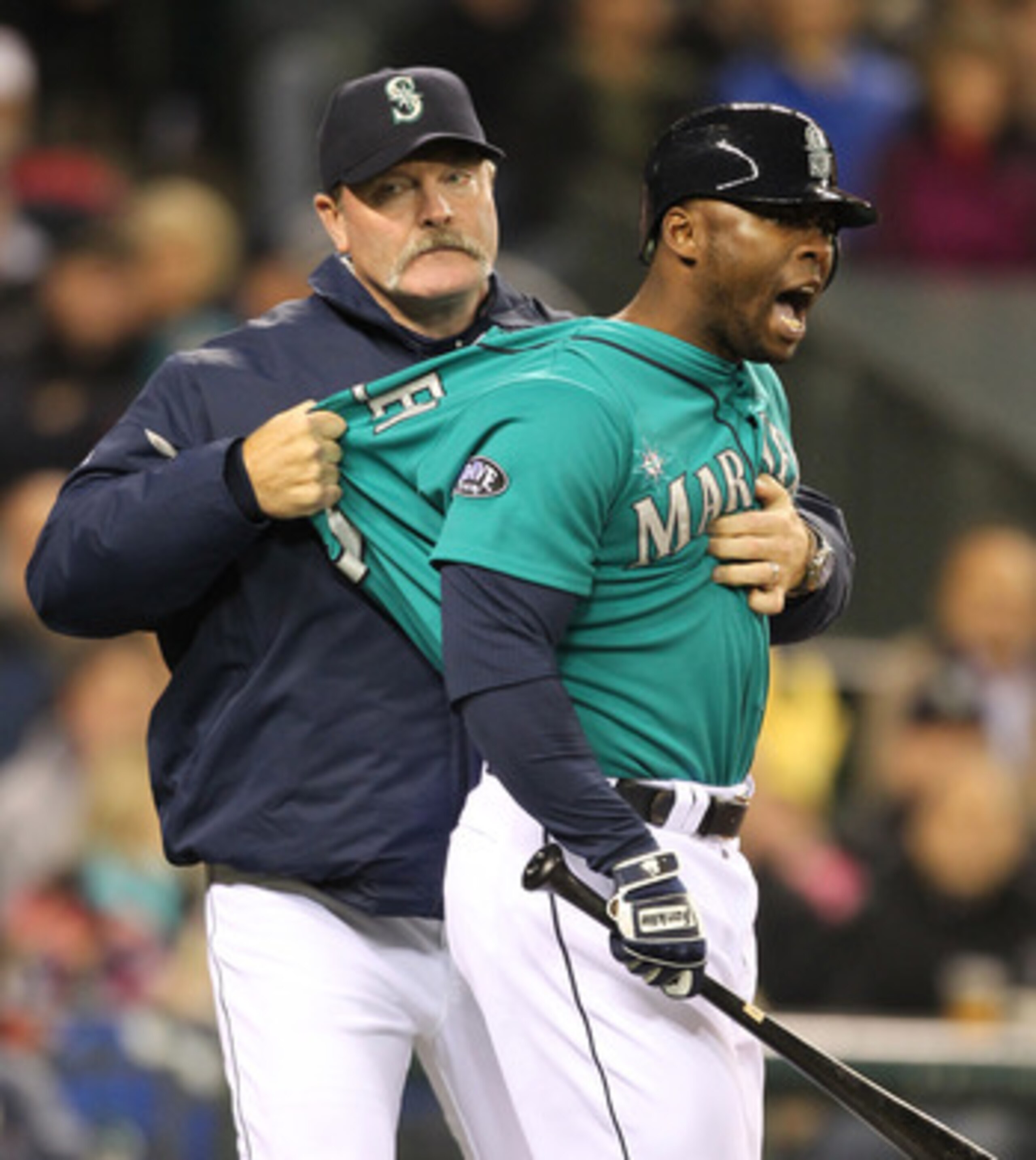 SEATTLE - FILE:  Milton Bradley #15 of the Seattle Mariners is restrained by manager Eric Wedge #22 after being ejected from the game against the Chicago White Sox at Safeco Field on May 6, 2011 in Seattle, Washington. According to reports May 9, 201, Bra