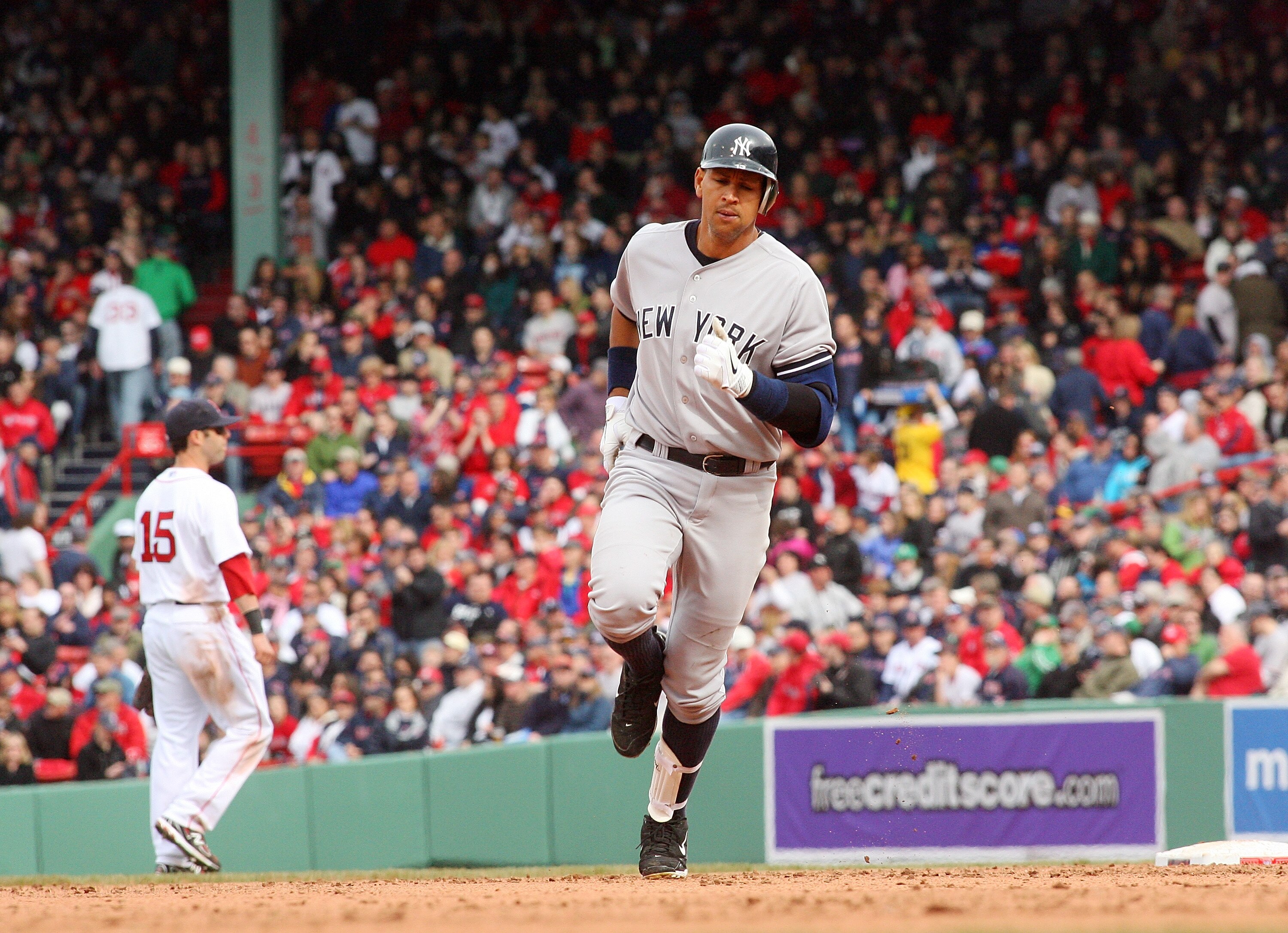 BOSTON, MA - APRIL 8:  Justin Pedroia #15 of the Boston Red Sox reacts as Alex Rodriguez #13 of the New York Yankees rounds the bases after hitting a home run in the fifth inning against the Boston Red Sox during opening game at Fenway Park, April 8, 2011