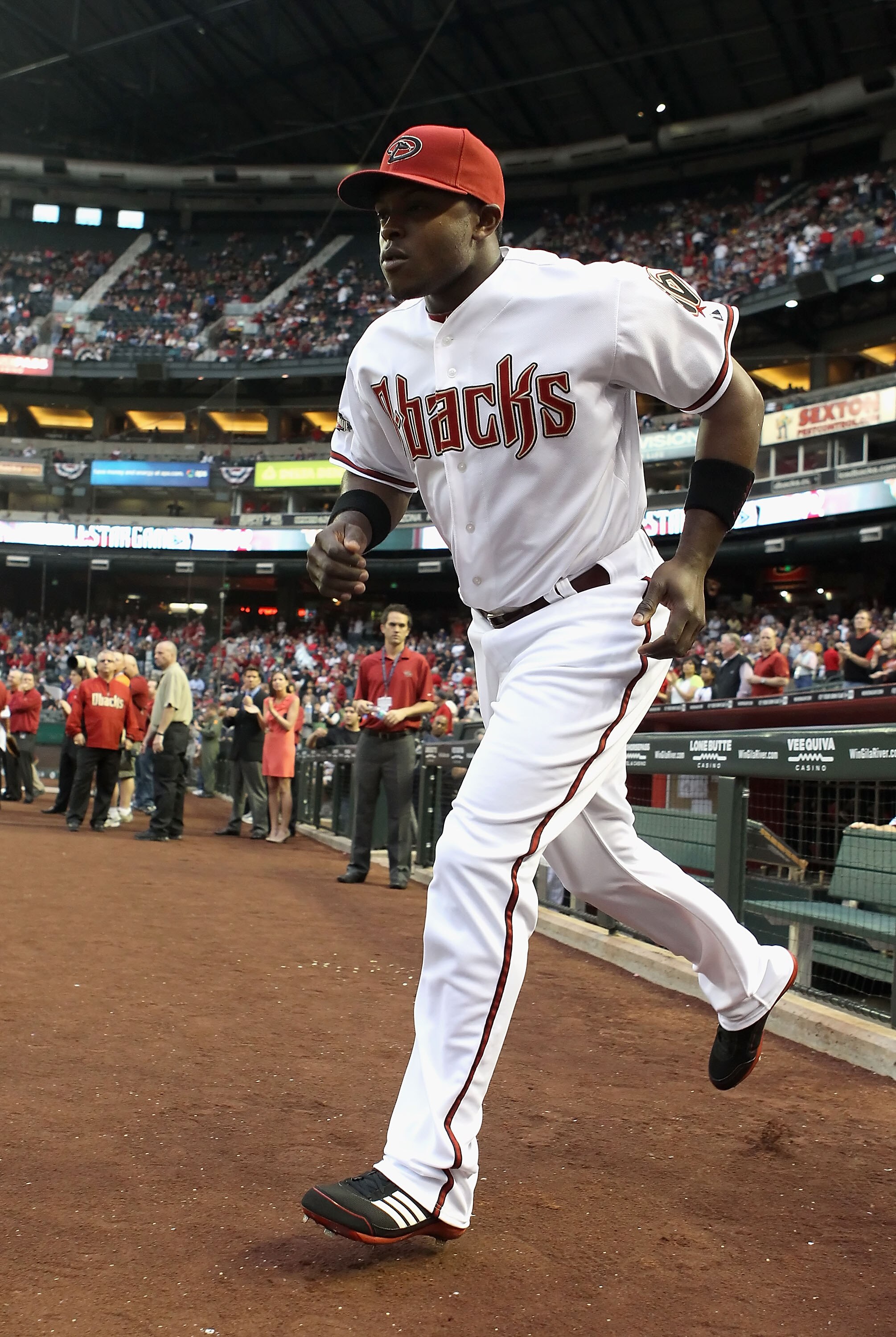 PHOENIX, AZ - APRIL 08:  Justin Upton #10 of the Arizona Diamondbacks runs out onto the field during introductions to the Major League Baseball home opening game against the Cincinnati Reds at Chase Field on April 8, 2011 in Phoenix, Arizona. The Diamondb