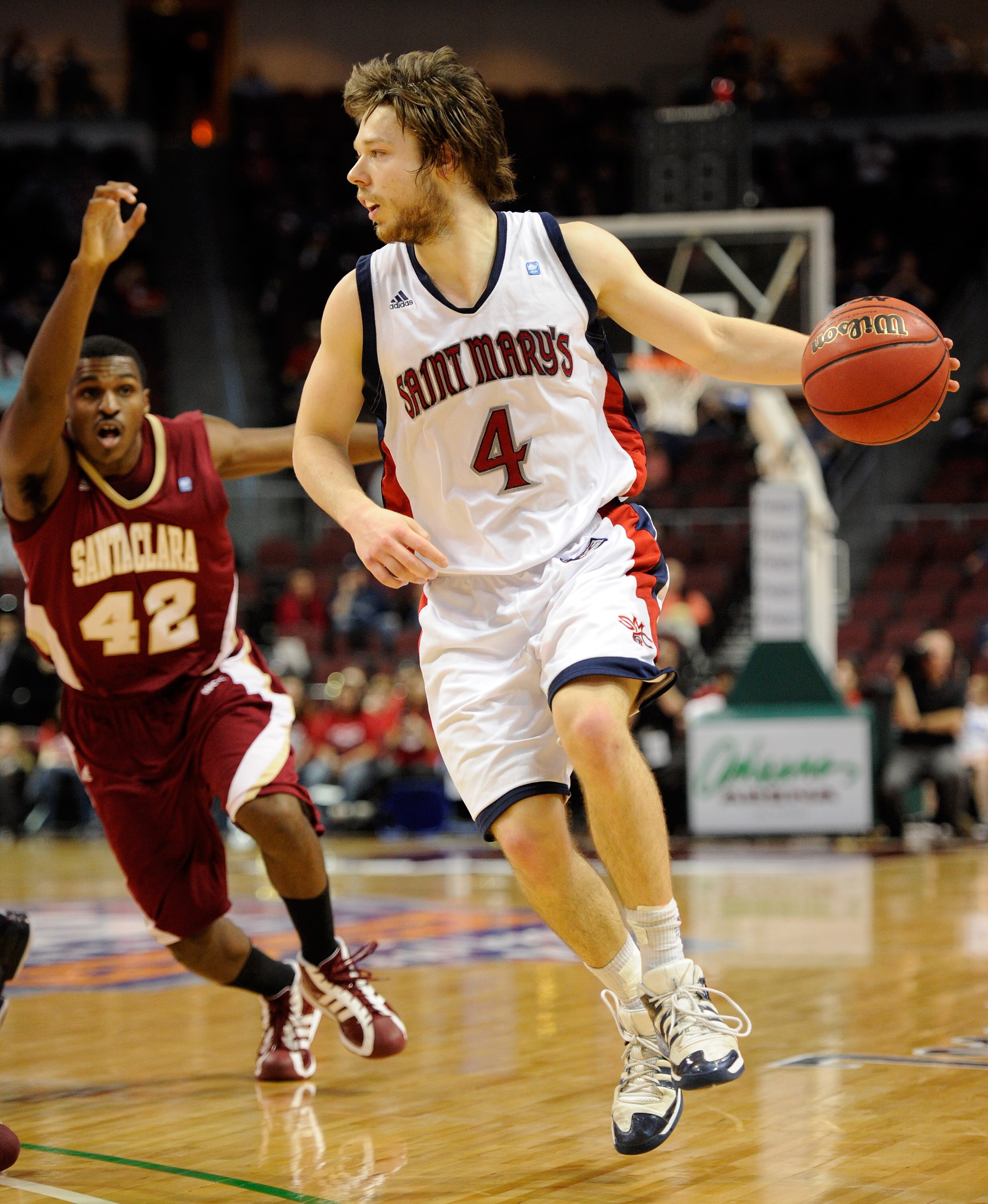 LAS VEGAS, NV - MARCH 06:  Matthew Dellavedova #4 of the Saint Mary's Gaels drives ahead of Raymond Cowels III #42 of the Santa Clara Broncos during a semifinal game of the Zappos.com West Coast Conference Basketball tournament at the Orleans Arena March