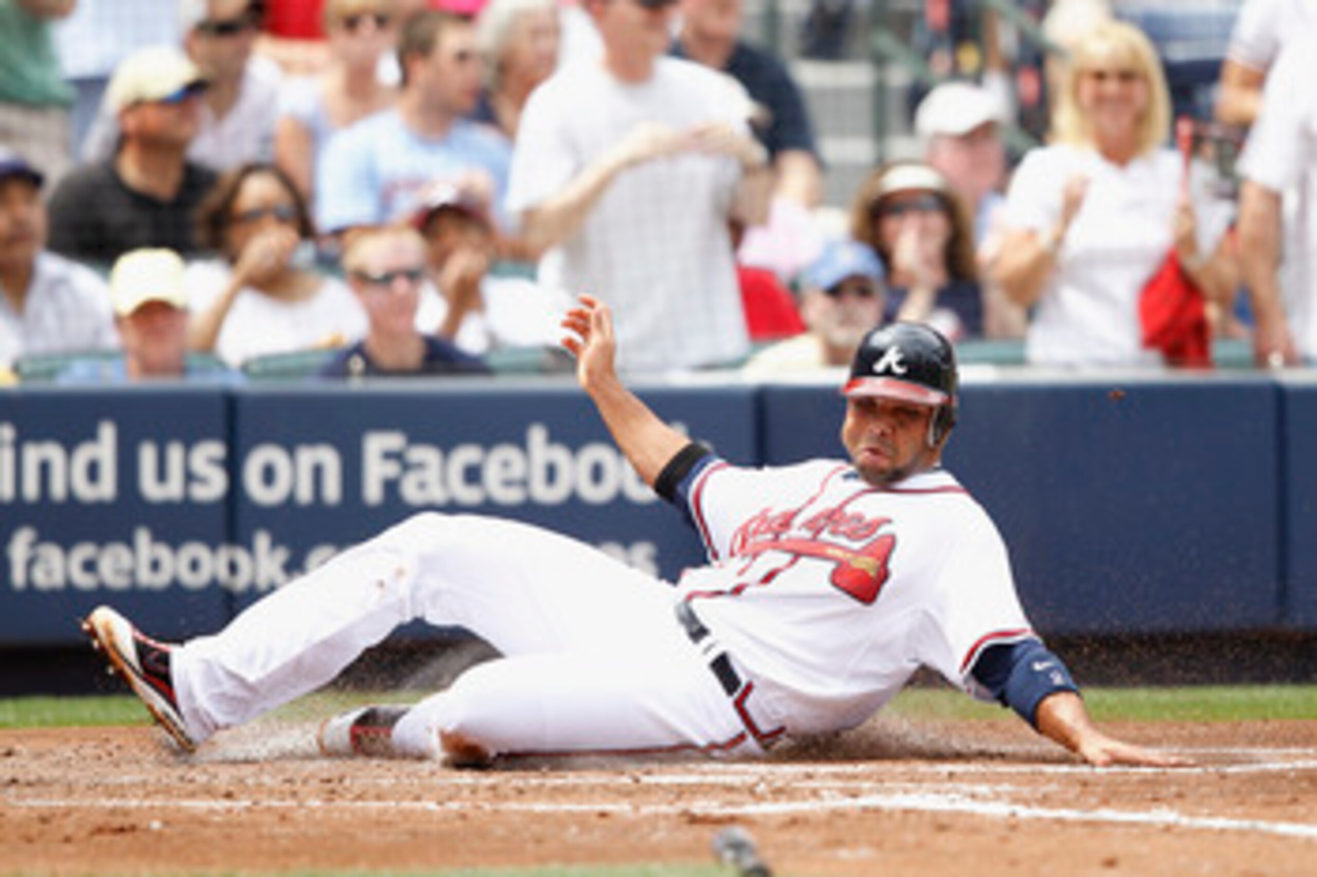 ATLANTA, GA - APRIL 9: Alex Gonzalez #2 of the Atlanta Braves slides at home plate to score a run against the Philadelphia Phillies at Turner Field on April 9, 2011 in Atlanta, Georgia. The Phillies won 10-2. (Photo by Joe Robbins/Getty Images)