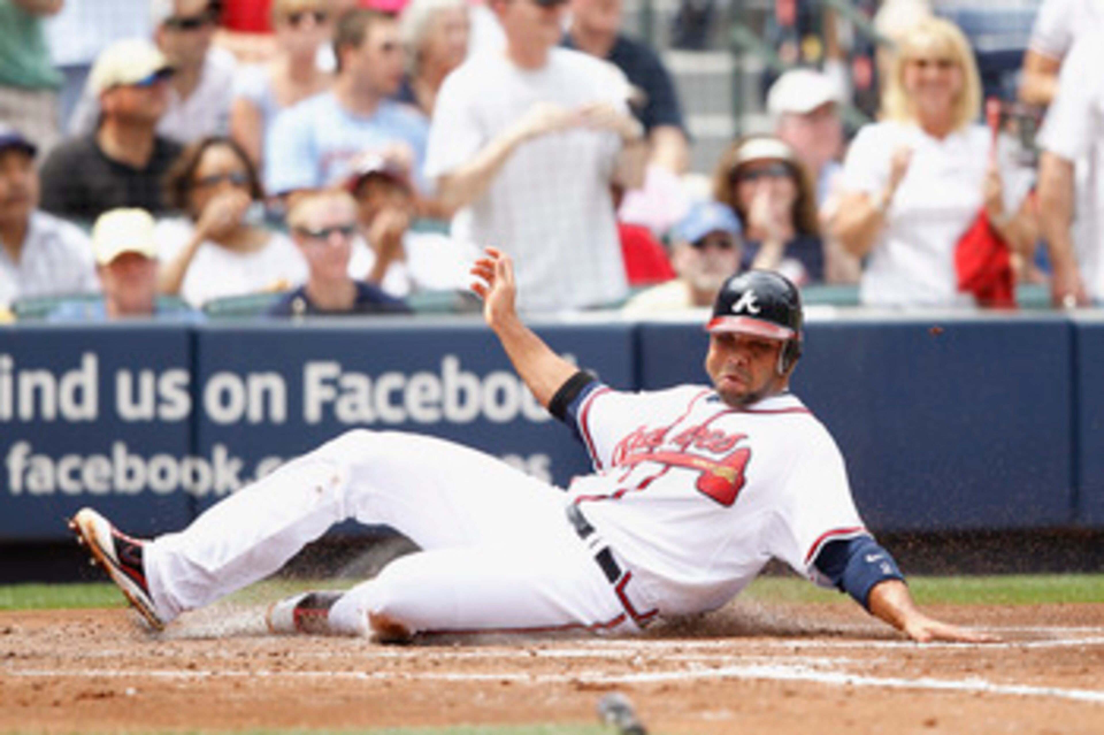 ATLANTA, GA - APRIL 9: Alex Gonzalez #2 of the Atlanta Braves slides at home plate to score a run against the Philadelphia Phillies at Turner Field on April 9, 2011 in Atlanta, Georgia. The Phillies won 10-2. (Photo by Joe Robbins/Getty Images)
