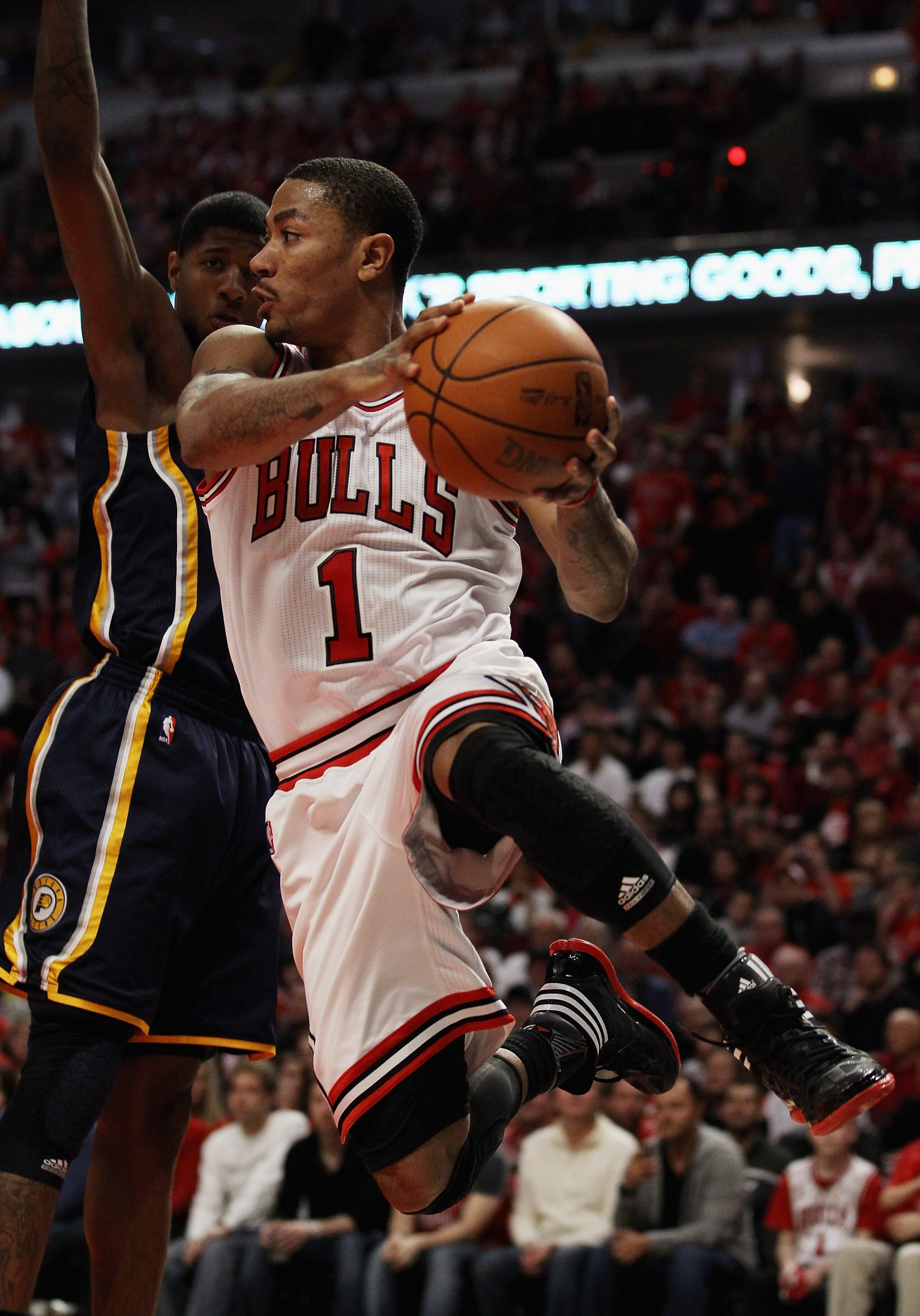 CHICAGO, IL - APRIL 16: Derrick Rose #1 of the Chicago Bulls leaps to pass the ball around Paul George #24 of the Indiana Pacers in Game One of the Eastern Conference Quarterfinals in the 2011 NBA Playoffs at the United Center on April 16, 2011 in Chicago CHICAGO, IL - APRIL 16: Derrick Rose #1 of the Chicago Bulls leaps to pass the ball around Paul George #24 of the Indiana Pacers in Game One of the Eastern Conference Quarterfinals in the 2011 NBA Playoffs at the United Center on April 16, 2011 in Chicago