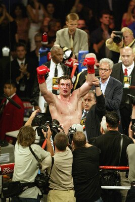LOS ANGELES - JUNE 21:  Vitali Klitschko raises his hands in the air to the crowd after the WBC and IBO World Heavyweight Championship bout against Lennox Lewis at the Staples Center on June 21, 2003 in Los Angeles, California.  Lennox Lewis (41-2-1) defe