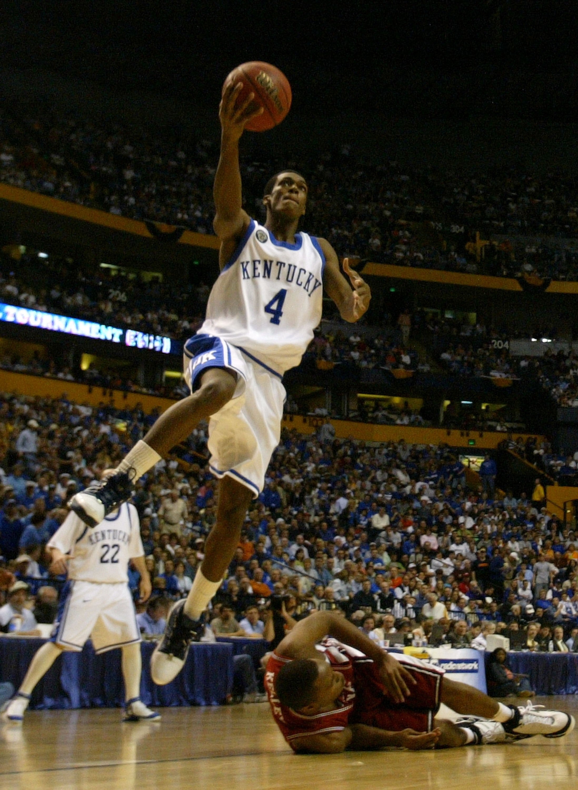 NASHVILLE, TN - MARCH 11:  Rajon Rondo #4 of the Kentucky Widcats drives for a shot attempt past Tarence Kinsey #21 (on floor) of the South Carolina Gamecocks during the semifinals on day 3 of the SEC Men's Basketball Conference Tournament March 11, 2006