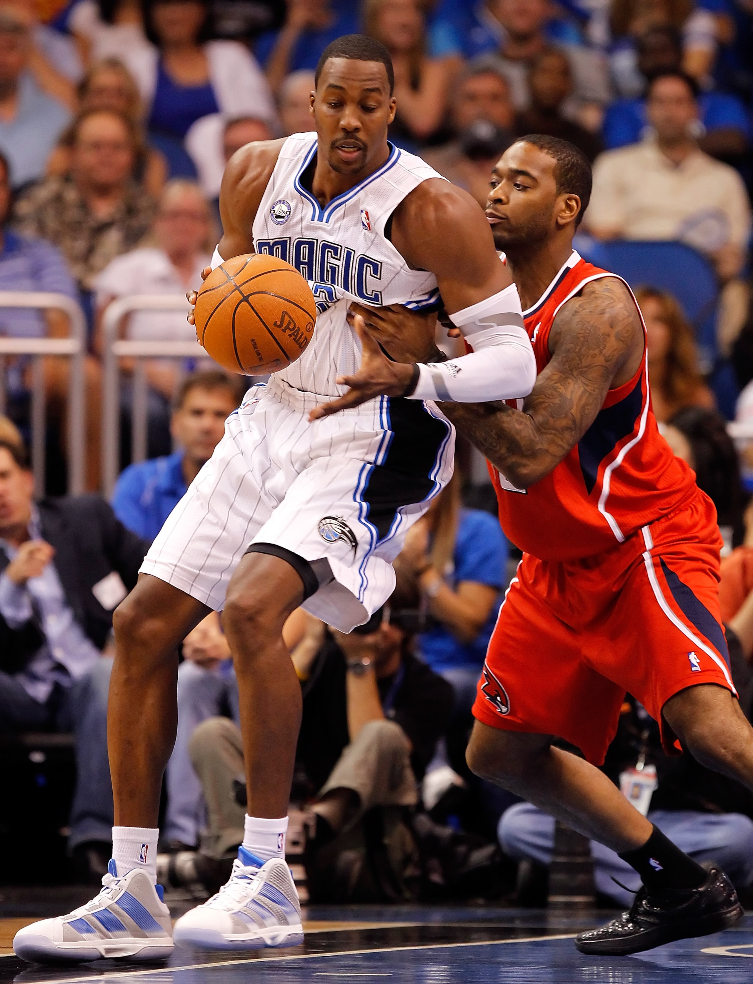 ORLANDO, FL - APRIL 16: Dwight Howard #12 of the Orlando Magic drives on Jason Collins #34 of the Atlanta Hawks during Game One of the Eastern Conference Quarterfinals of the 2011 NBA Playoffs on April 16, 2011 at the Amway Arena in Orlando, Florida. NO ORLANDO, FL - APRIL 16: Dwight Howard #12 of the Orlando Magic drives on Jason Collins #34 of the Atlanta Hawks during Game One of the Eastern Conference Quarterfinals of the 2011 NBA Playoffs on April 16, 2011 at the Amway Arena in Orlando, Florida. NO