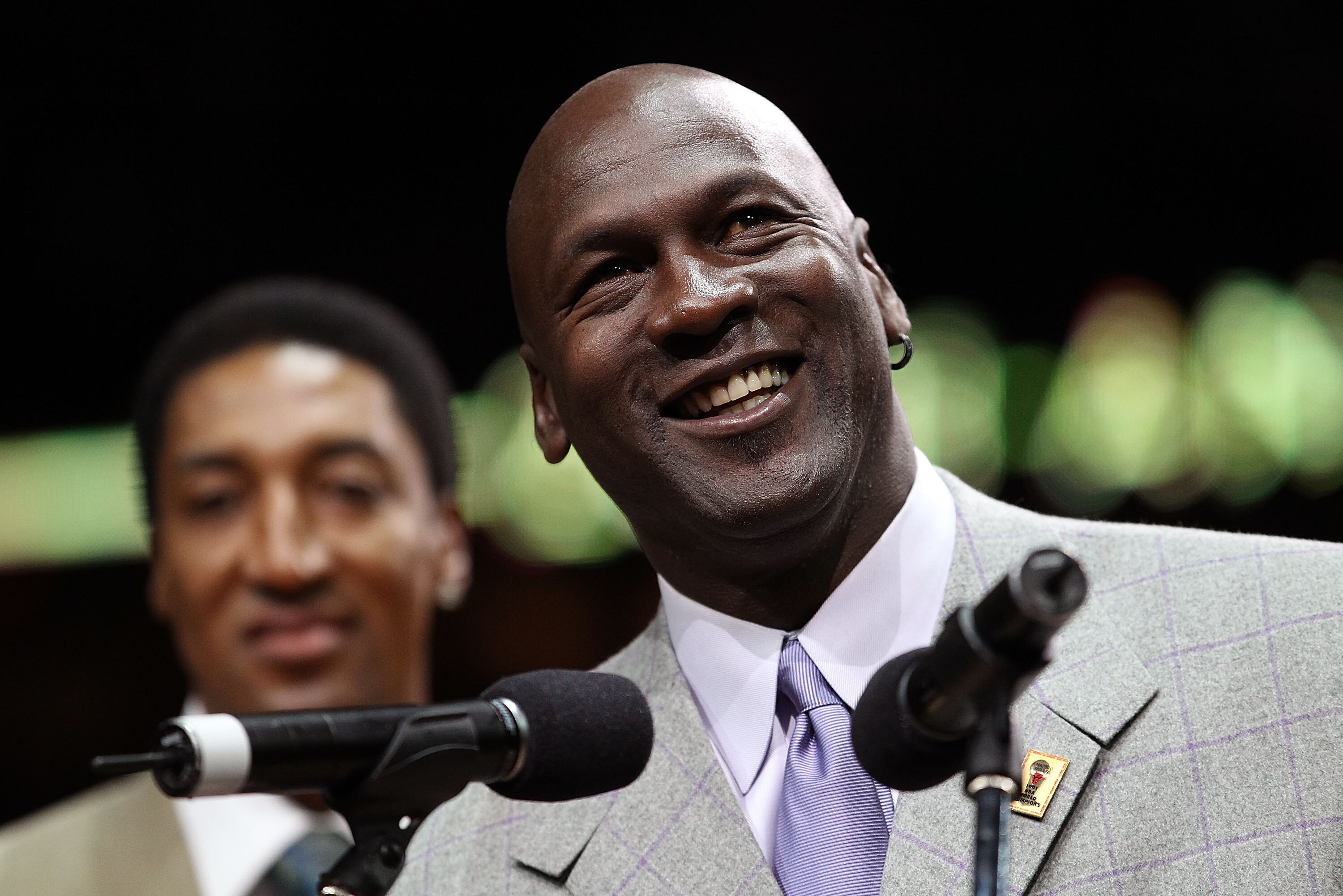 CHICAGO, IL - MARCH 12: Former player Michael Jordan of the Chicago Bulls addresses the crowd as teammate Scottie Pippen listens during a 20th anniversary recognition ceremony of the Bulls 1st NBA Championship in 1991 during half-time of a game bewteen th