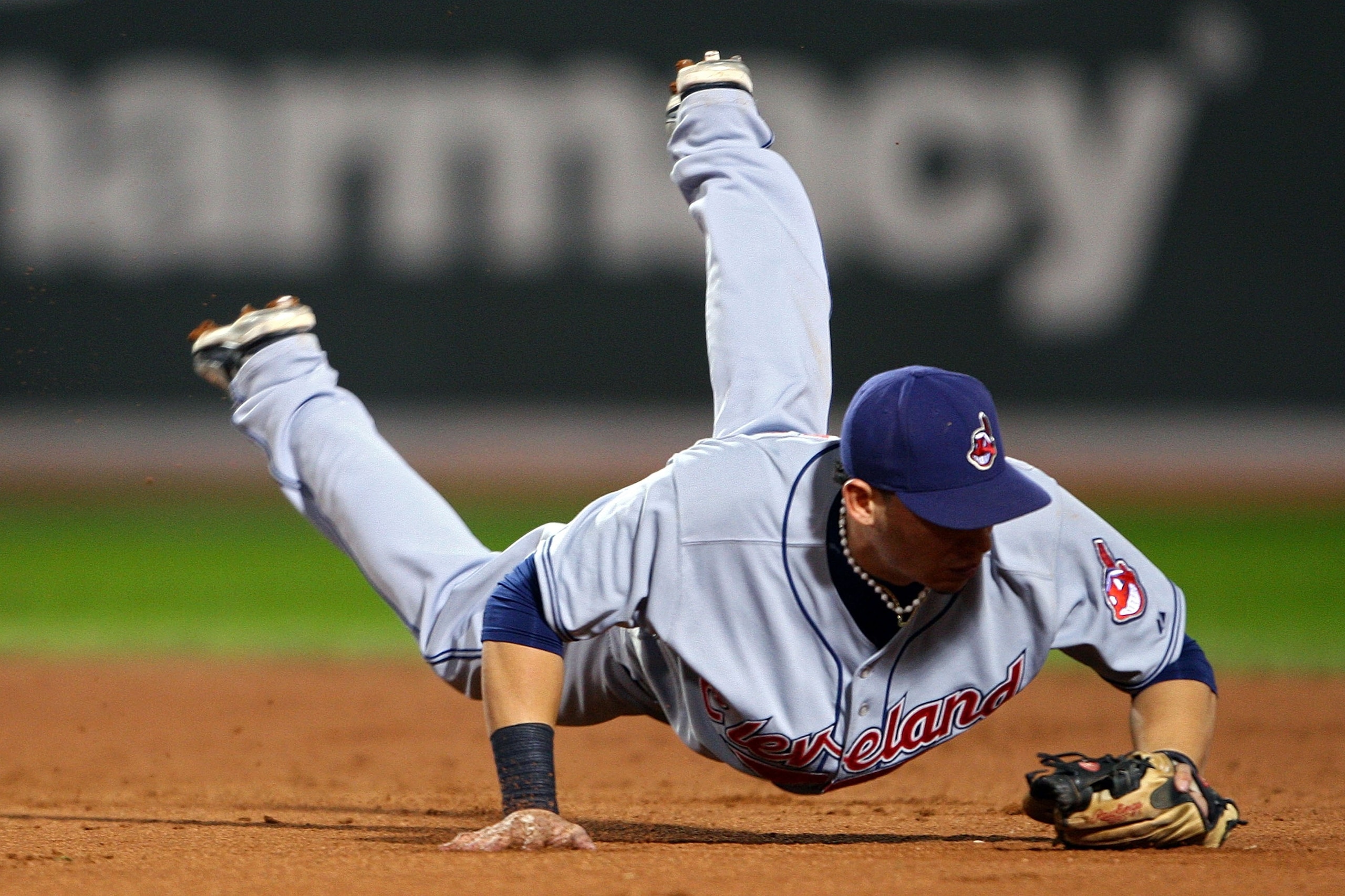BOSTON - OCTOBER 21:  Asdrubal Cabrera #13 of the Cleveland Indians dives for but fail to catch a grounder hit by Julio Lugo #23 of the Boston Red Sox during Game Seven of the American League Championship Series at Fenway Park on October 21, 2007 in Bosto