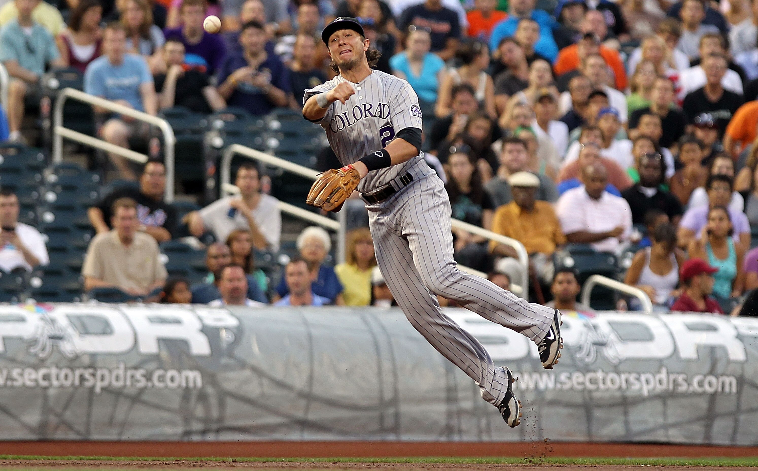 NEW YORK - AUGUST 11: Troy Tulowitzki #2 of the Colorado Rockies throws to first for the out against the New York Mets at Citi Field on August 11, 2010 in the Flushing neighborhood of the Queens borough of New York City.  (Photo by Nick Laham/Getty Images