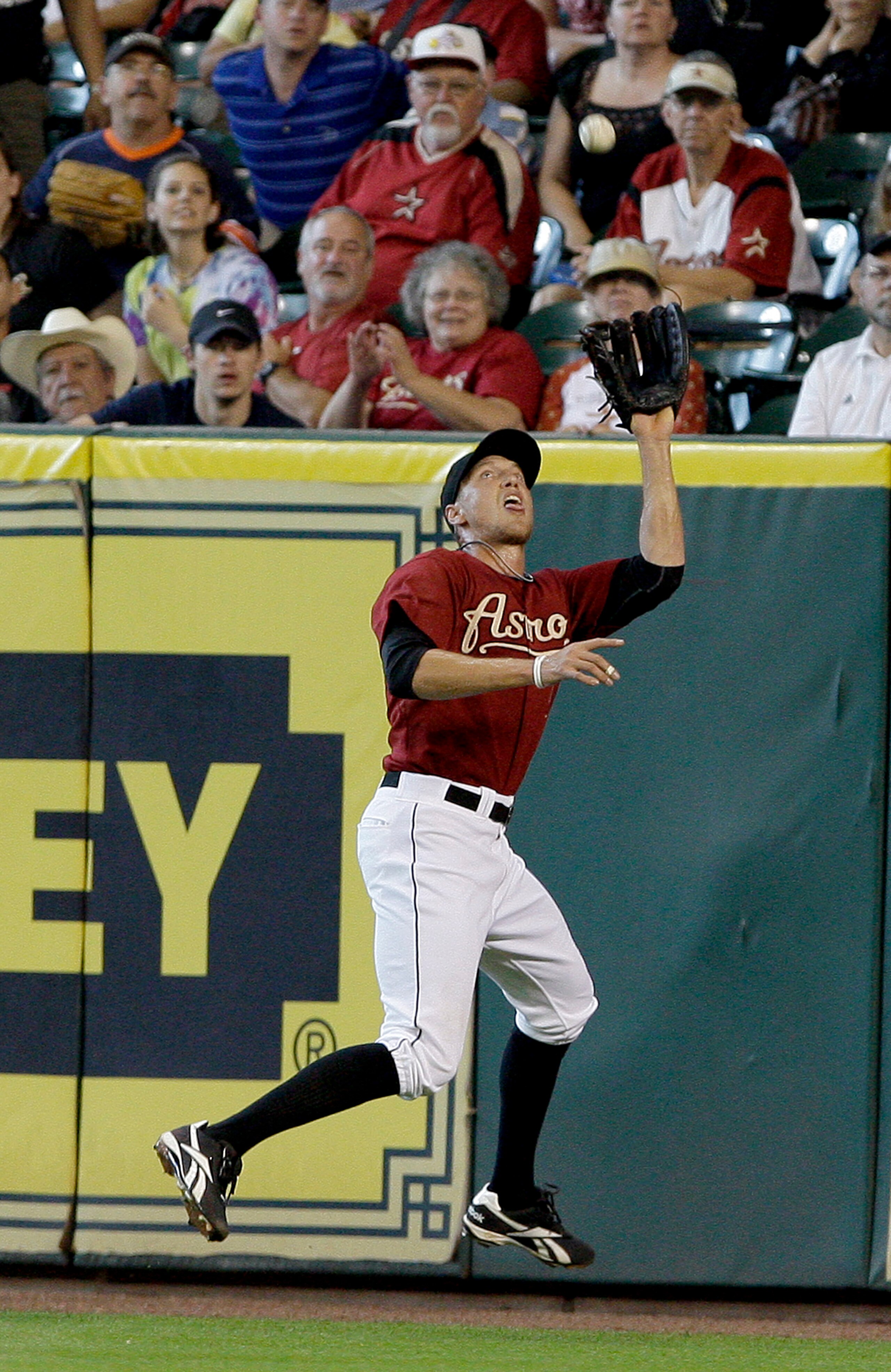 HOUSTON,TX- APRIL 10 : Right fielder Hunter Pence #9  of the Houston Astros catches Wes Helms #18 of the Florida Marlins fly ball on the warning track in the second inning in a MLB  baseball game on April 10, 2011 at Minute Maid Park in Houston, Texas. (P