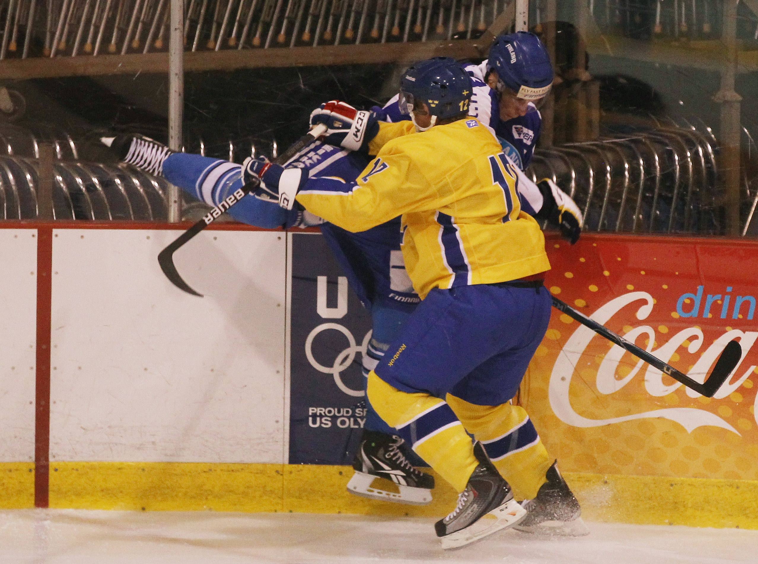 LAKE PLACID, NY - AUGUST 05:  Jonnas Nattinen #29  of Team Finland is hit into the boards by Gabriel Landeskog #12 of Team Sweden at the USA Hockey National Evaluation Camp on August 5, 2010 in Lake Placid, New York.  (Photo by Bruce Bennett/Getty Images)