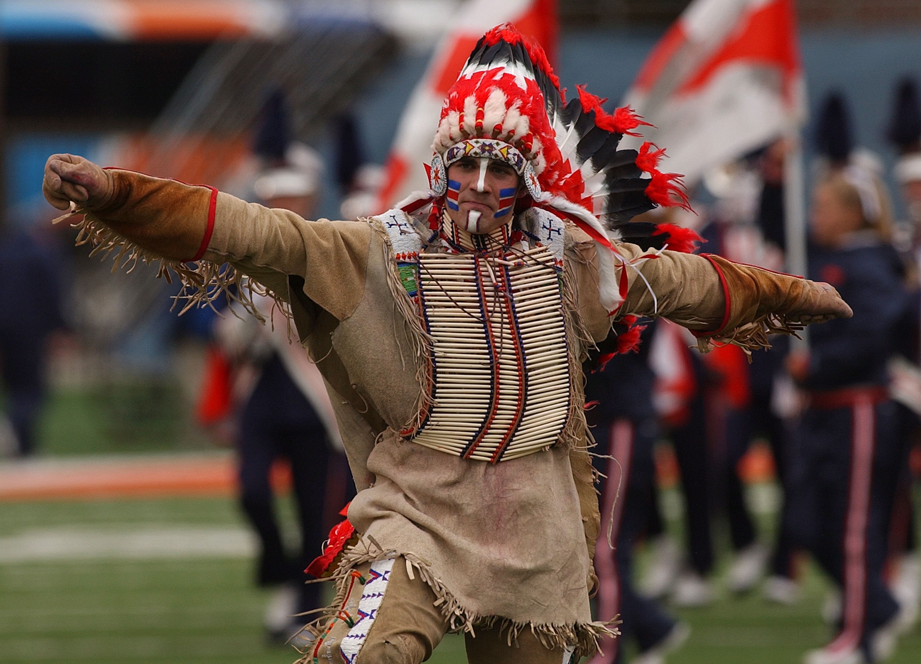 CHAMPAIGN, IL - OCTOBER 16: Controversial symbol 'Chief Illiniwek' of the University of Illinois performs during the half-time show of a game between Illinois and Michigan at Memorial Stadium October 16, 2004 in Champaign, Illinois. Michigan defeated Illi