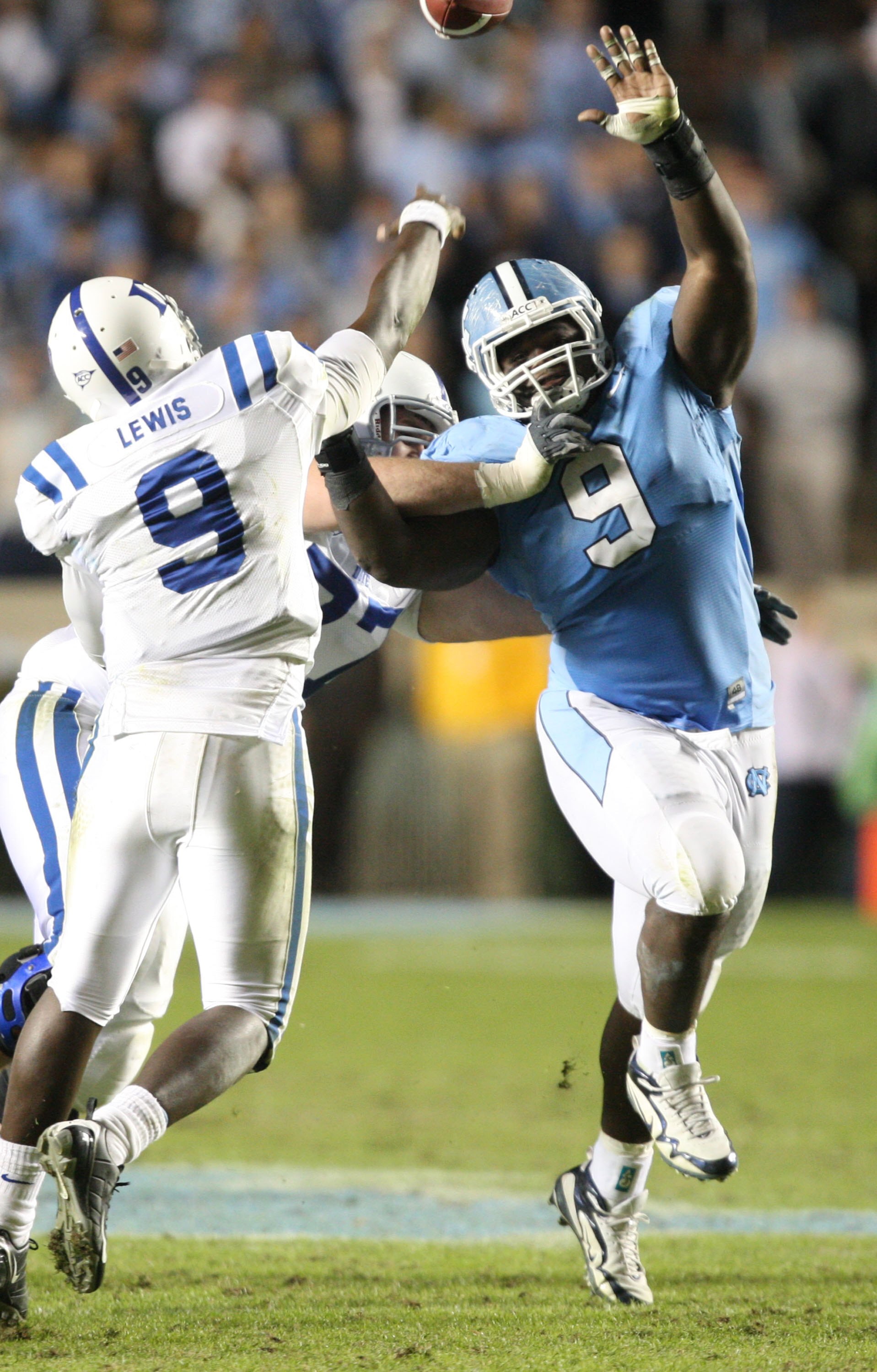 CHAPEL HILL, NC - NOVEMBER 7:  Marvin Austin #9 of the North Carolina Tar Heels pressures Thaddeus Lewis #9 of the Duke Blue Devils at Kenan Stadium on November 7, 2009 in Chapel Hill, North Carolina. (Photo by Streeter Lecka/Getty Images)