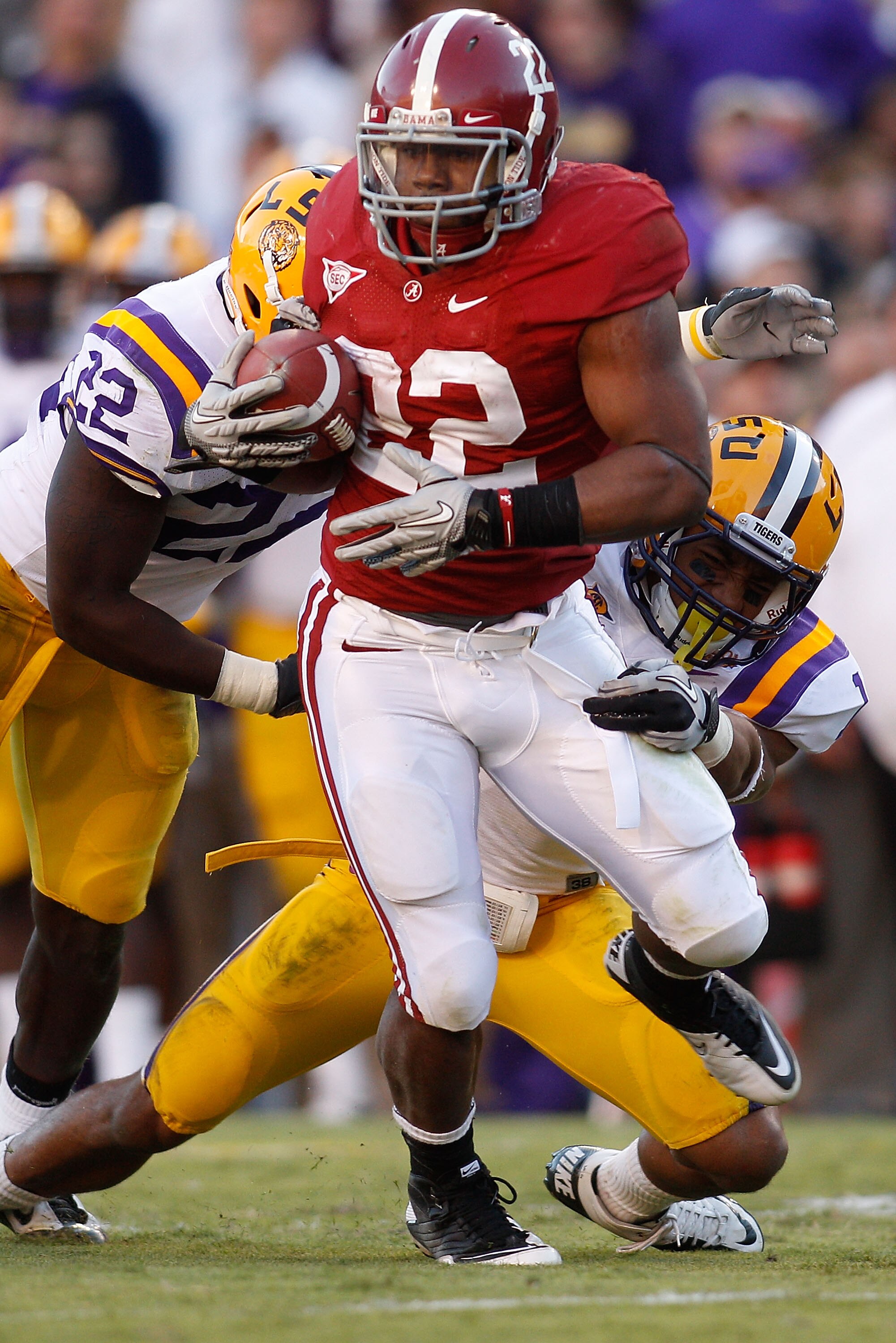 BATON ROUGE, LA - NOVEMBER 06:  Mark Ingram #22 of the Alabama Crimson Tide is tackled by Eric Reid #1 and Ryan Baker #22 of the Louisiana State University Tigers at Tiger Stadium on November 6, 2010 in Baton Rouge, Louisiana.  The Tigers defeated the Cri