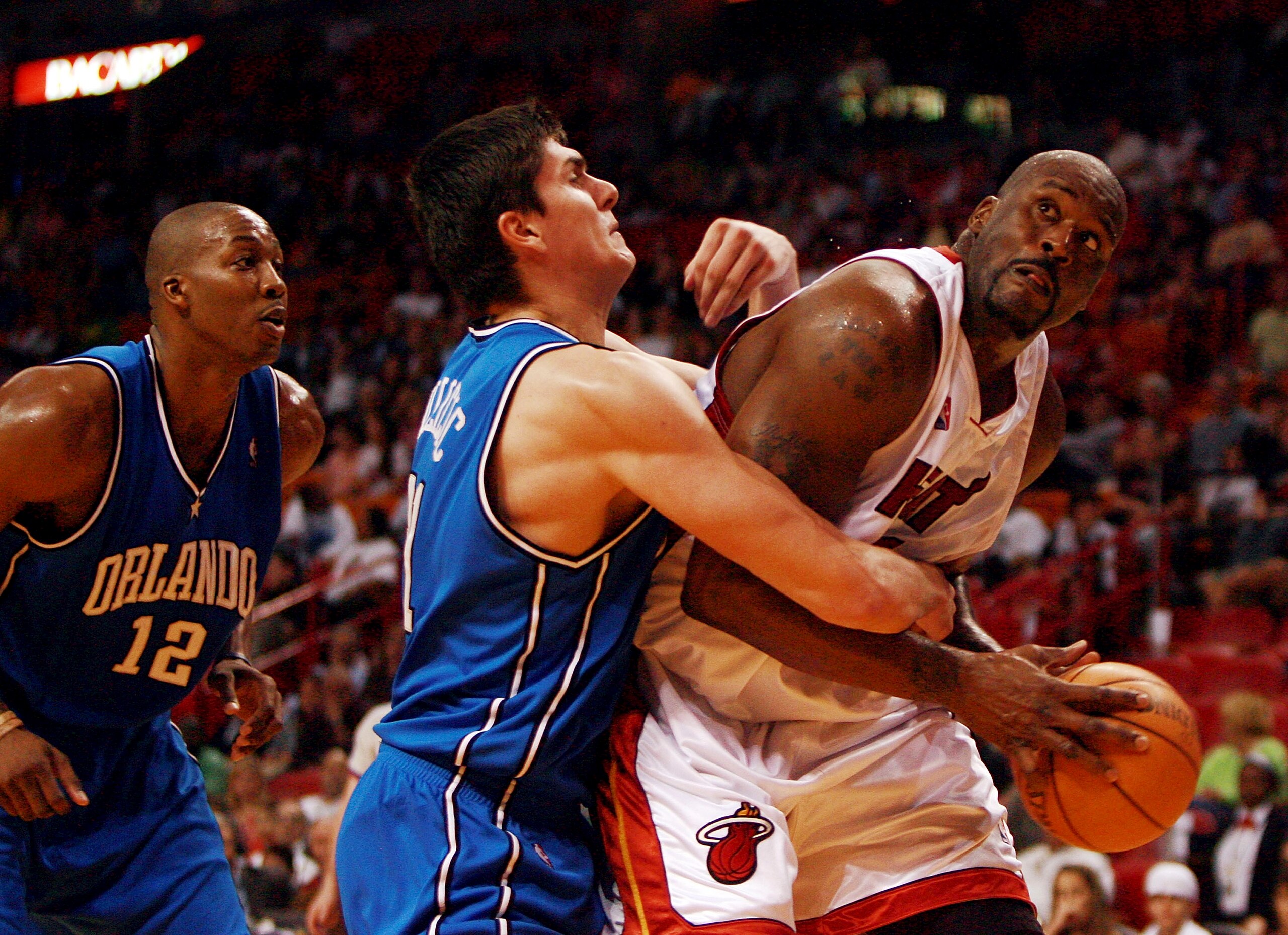 MIAMI - MARCH 18:  Shaquille O'Neal #32 of the Miami Heat is fouled by Darko Milicic #31 of the Orlando Magic at American Airlines Arena on March 18, 2007 in Miami, Florida. NOTE TO USER: User expressly acknowledges and agrees that, by downloading and or