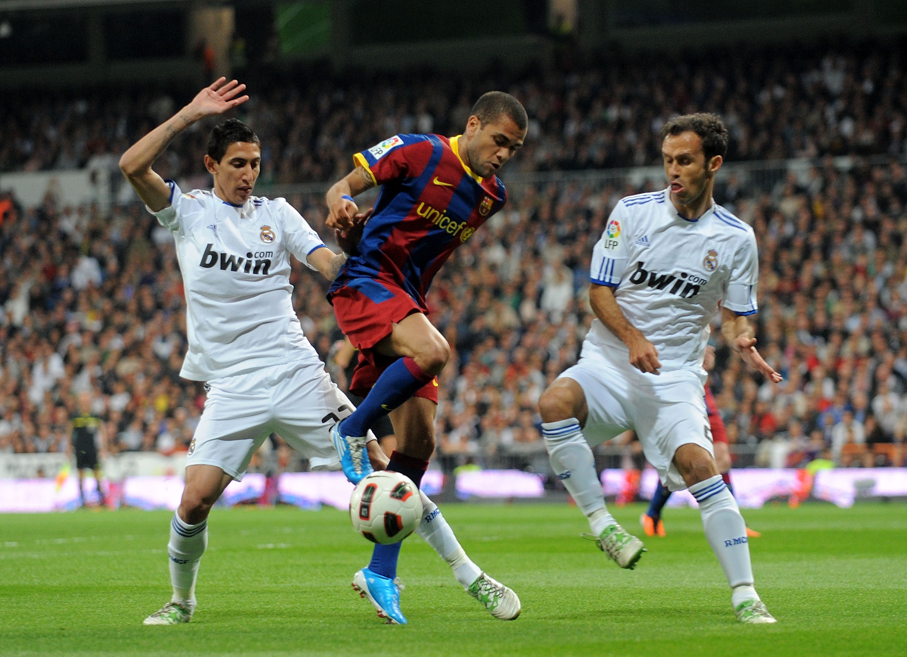 MADRID, SPAIN - APRIL 16: Dani Alves (C) of Barcelona is tackled by Marcelo (L) and Ricardo Carvalho of Real Madrid during the La Liga match between Real Madrid and Barcelona at Estadio Santiago Bernabeu on April 16, 2011 in Madrid, Spain.  (Photo by Deni