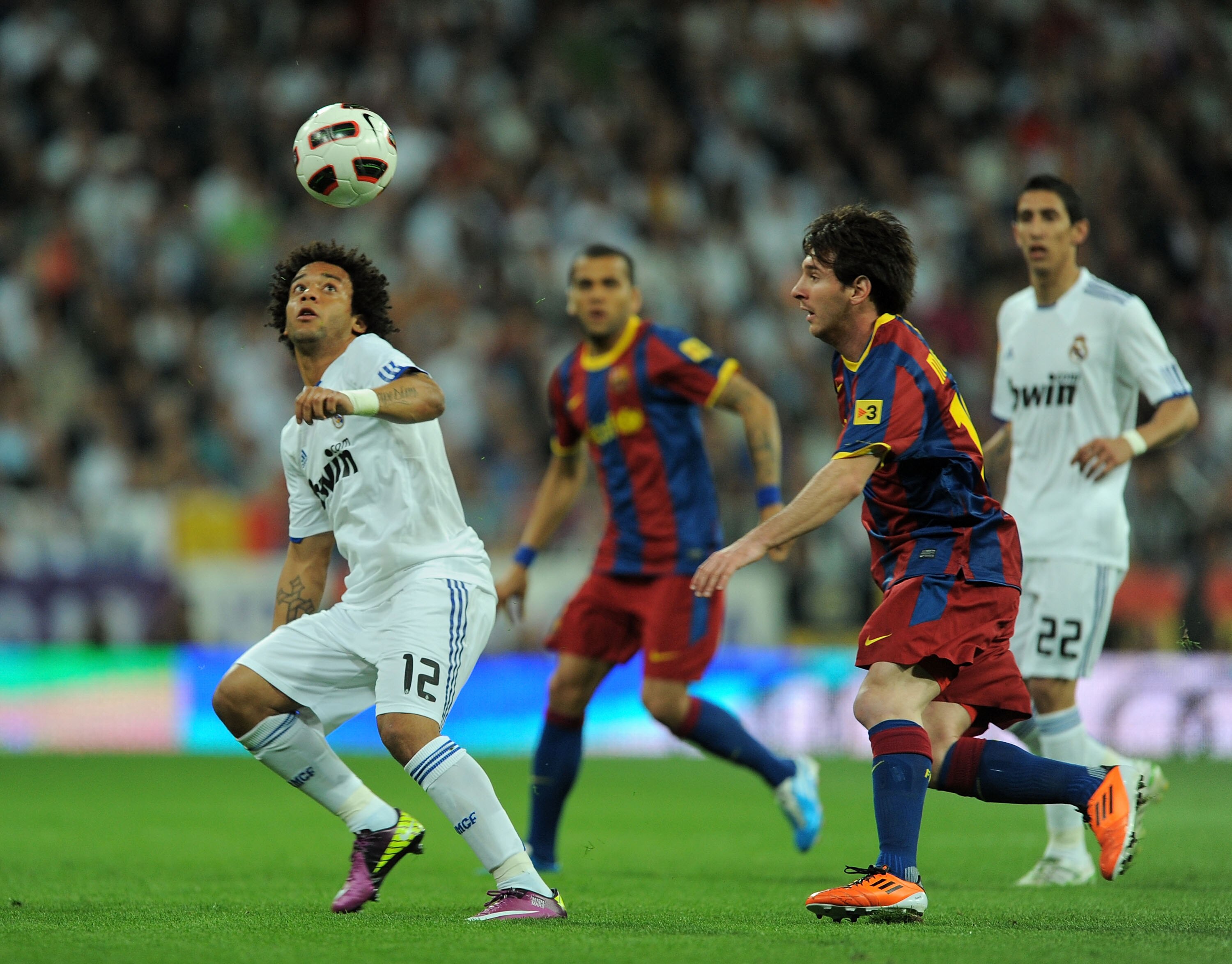 MADRID, SPAIN - APRIL 16:  Marcelo (L) of Real Madrid heads the ball beside Lionel Messi of Barcelona during the La Liga match between Real Madrid and Barcelona at Estadio Santiago Bernabeu on April 16, 2011 in Madrid, Spain.  (Photo by Denis Doyle/Getty