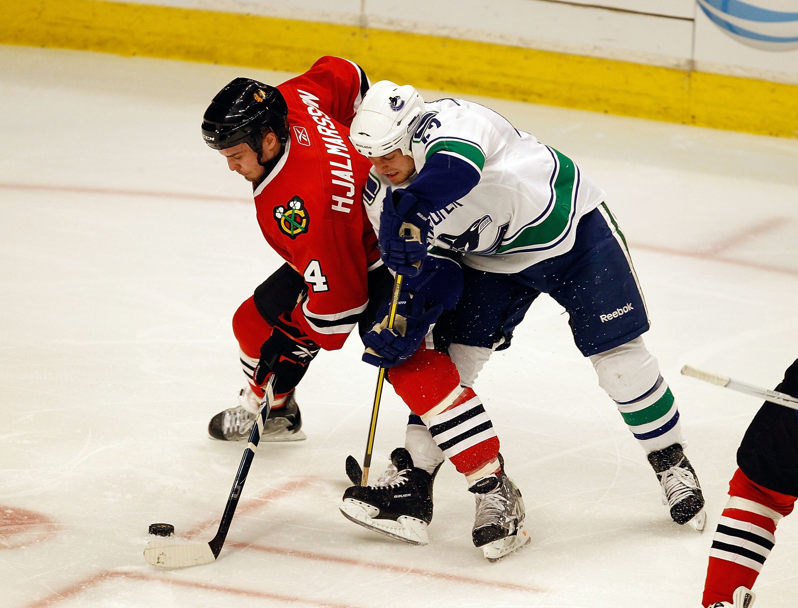 CHICAGO - MAY 03: Niklas Hjalmarsson #4 of the Chicago Blackhawks and Andrew Alberts #41 of the Vancouver Canucks battle for the puck in Game Two of the Western Conference Semifinals during the 2010 NHL Stanley Cup Playoffs at United Center on May 3, 2010 CHICAGO - MAY 03: Niklas Hjalmarsson #4 of the Chicago Blackhawks and Andrew Alberts #41 of the Vancouver Canucks battle for the puck in Game Two of the Western Conference Semifinals during the 2010 NHL Stanley Cup Playoffs at United Center on May 3, 2010