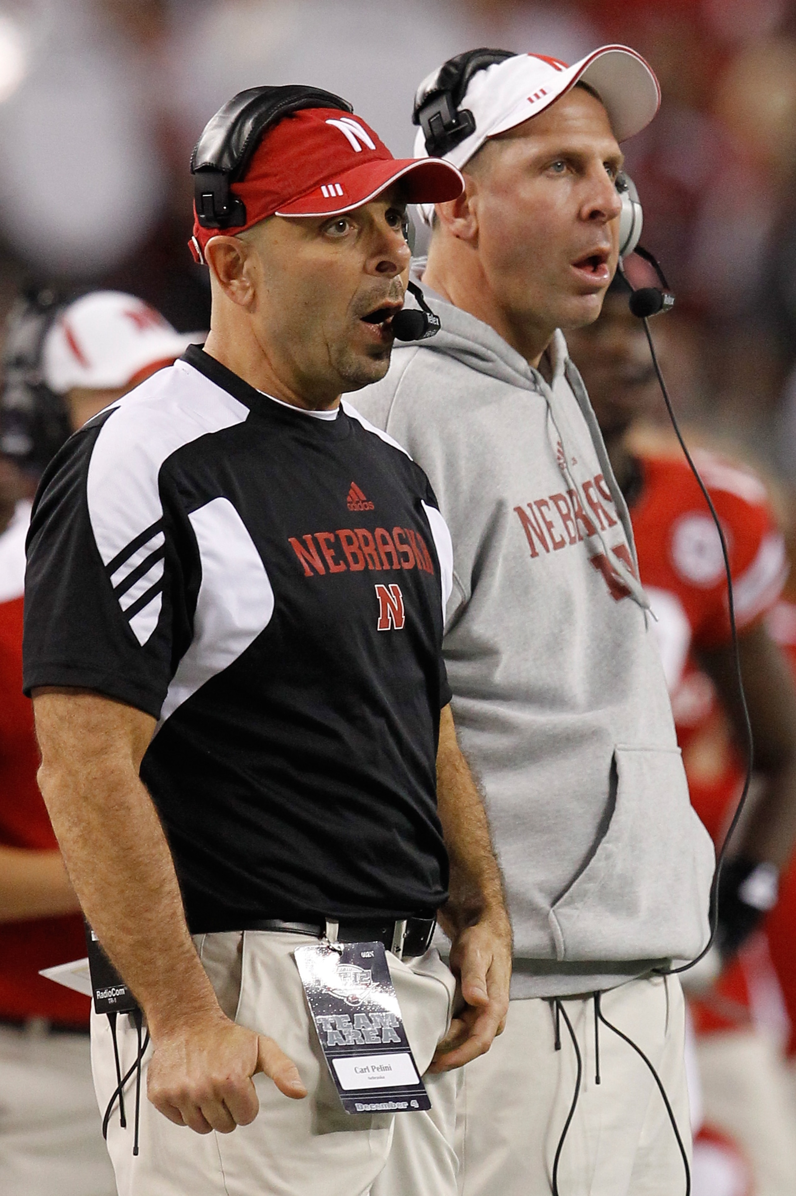 ARLINGTON, TX - DECEMBER 04: Head coach Bo Pelini (R) of the Nebraska Cornhuskers and defensive coordinator Carl Pelini lead their team against the Oklahoma Sooners at Cowboys Stadium on December 4, 2010 in Arlington, Texas. The Sooners beat the Cornhusk ARLINGTON, TX - DECEMBER 04: Head coach Bo Pelini (R) of the Nebraska Cornhuskers and defensive coordinator Carl Pelini lead their team against the Oklahoma Sooners at Cowboys Stadium on December 4, 2010 in Arlington, Texas. The Sooners beat the Cornhusk