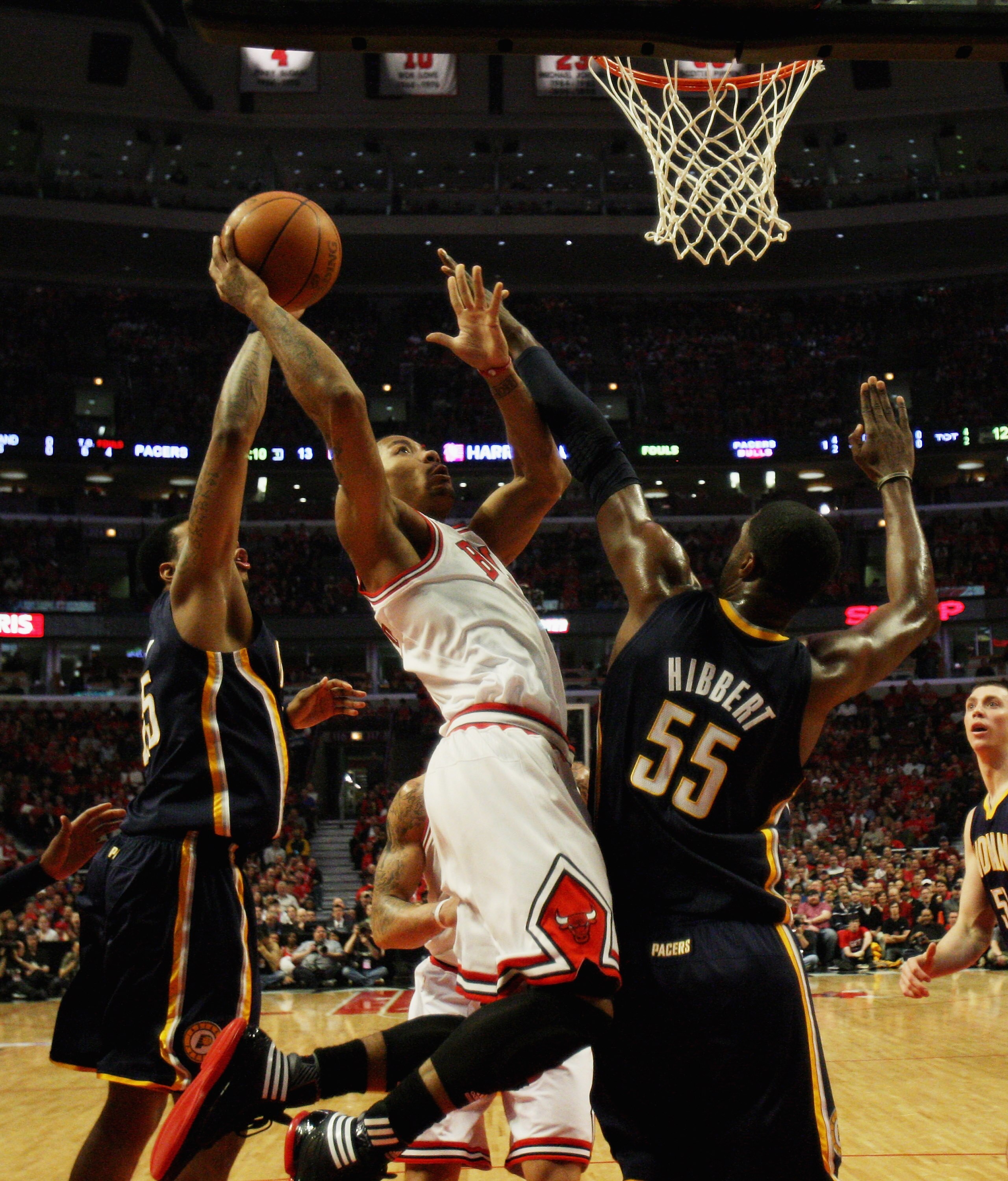 CHICAGO, IL - APRIL 16: Derrick Rose #1 of the Chicago Bulls puts up a shot between Brandon Rush #25 and Roy Hibbert #55 of the Indiana Pacers in Game One of the Eastern Conference Quarterfinals in the 2011 NBA Playoffs at the United Center on April 16, 2