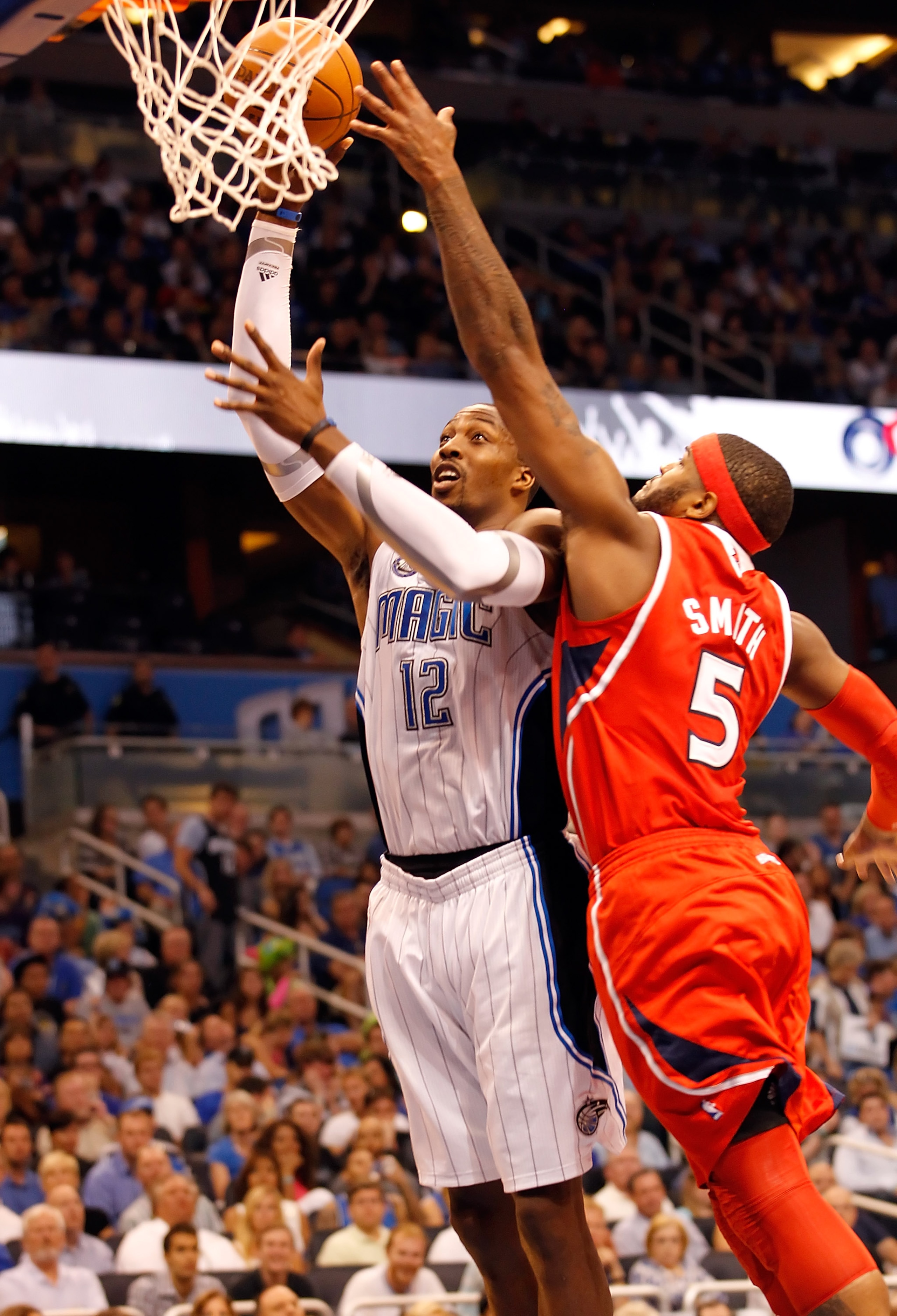 ORLANDO, FL - APRIL 16:  Dwight Howard #12 of the Orlando Magic shoots over Josh Smith #5 of the Atlanta Hawks during Game One of the Eastern Conference Quarterfinals of the 2011 NBA Playoffs on April 16, 2011 at the Amway Arena in Orlando, Florida.  NOTE