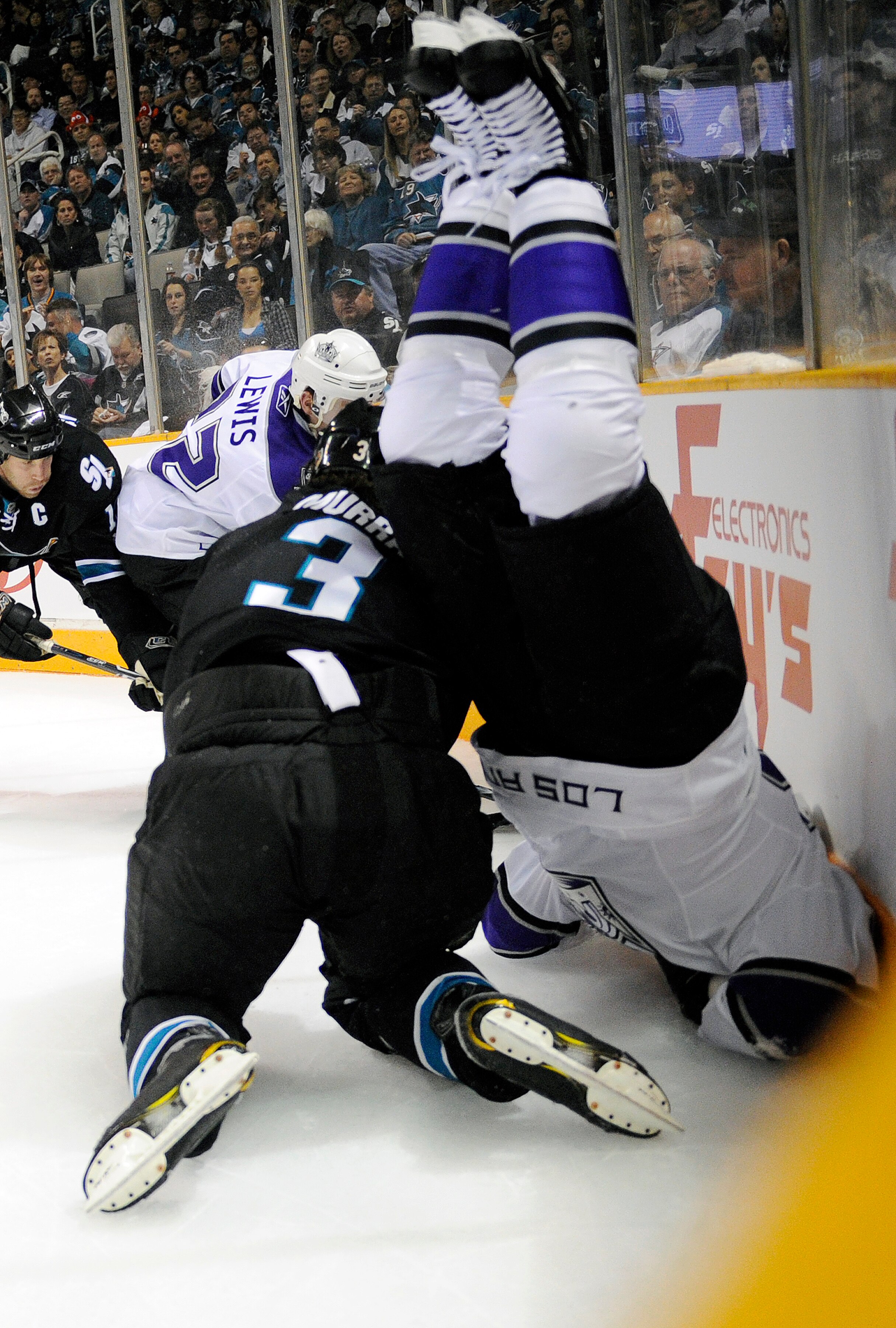 SAN JOSE, CA - APRIL 14: Dustin Brown #23 of the Los Angeles Kings flips over Douglas Murray #3 of the San Jose Sharks in Game One of the Western Conference Quarterfinals  during the 2011 NHL Stanley Cup Playoffs at the HP Pavilion on April 14, 2011 in Sa