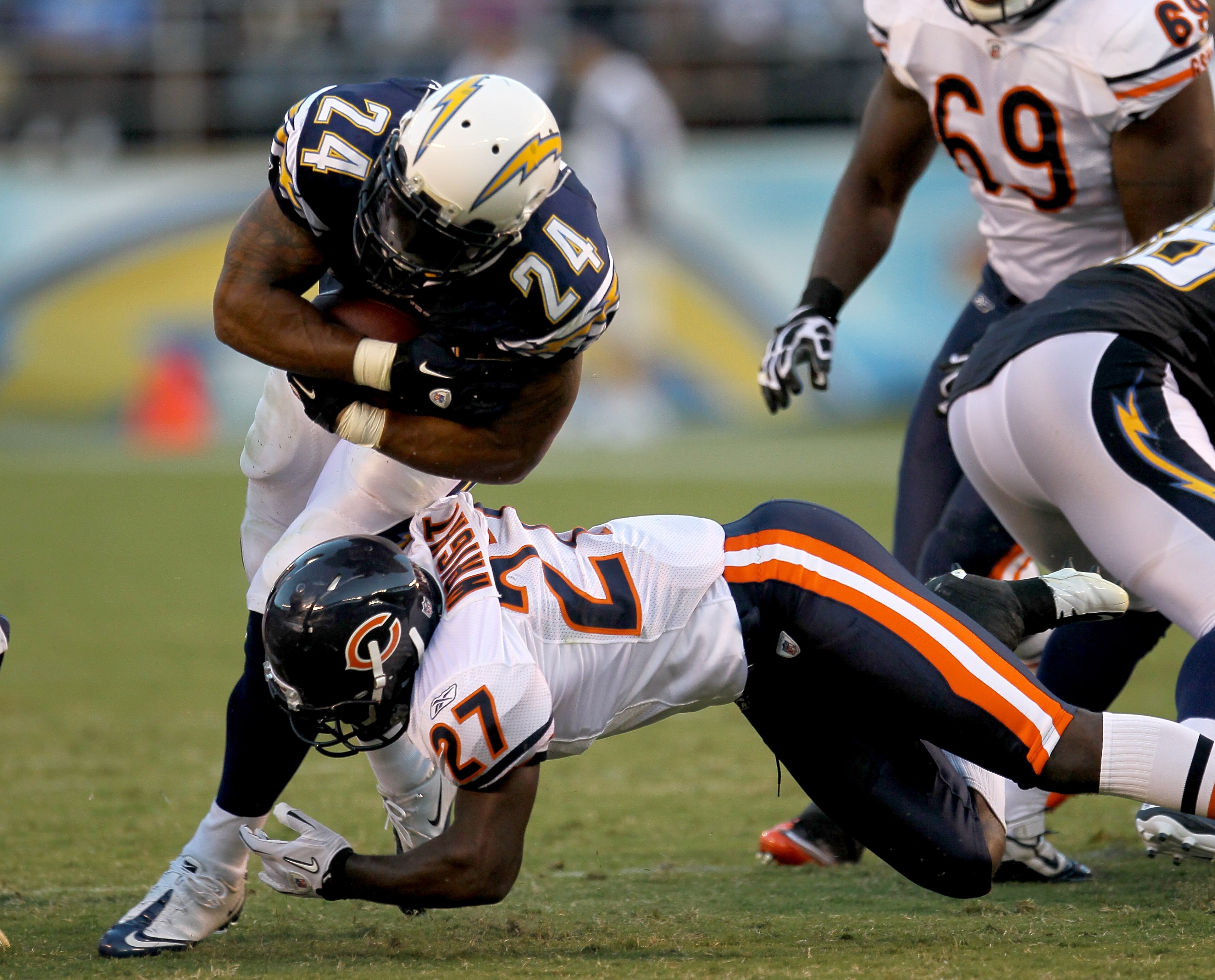 SAN DIEGO - AUGUST 14:  Running back Ryan Mathews #24 of the San Diego Chargers carries for a first down on fourth and one before being tackled by safety Major Wright #27 of the Chicago Bears on August 14, 2010 at Qualcomm Stadium in San Diego, California