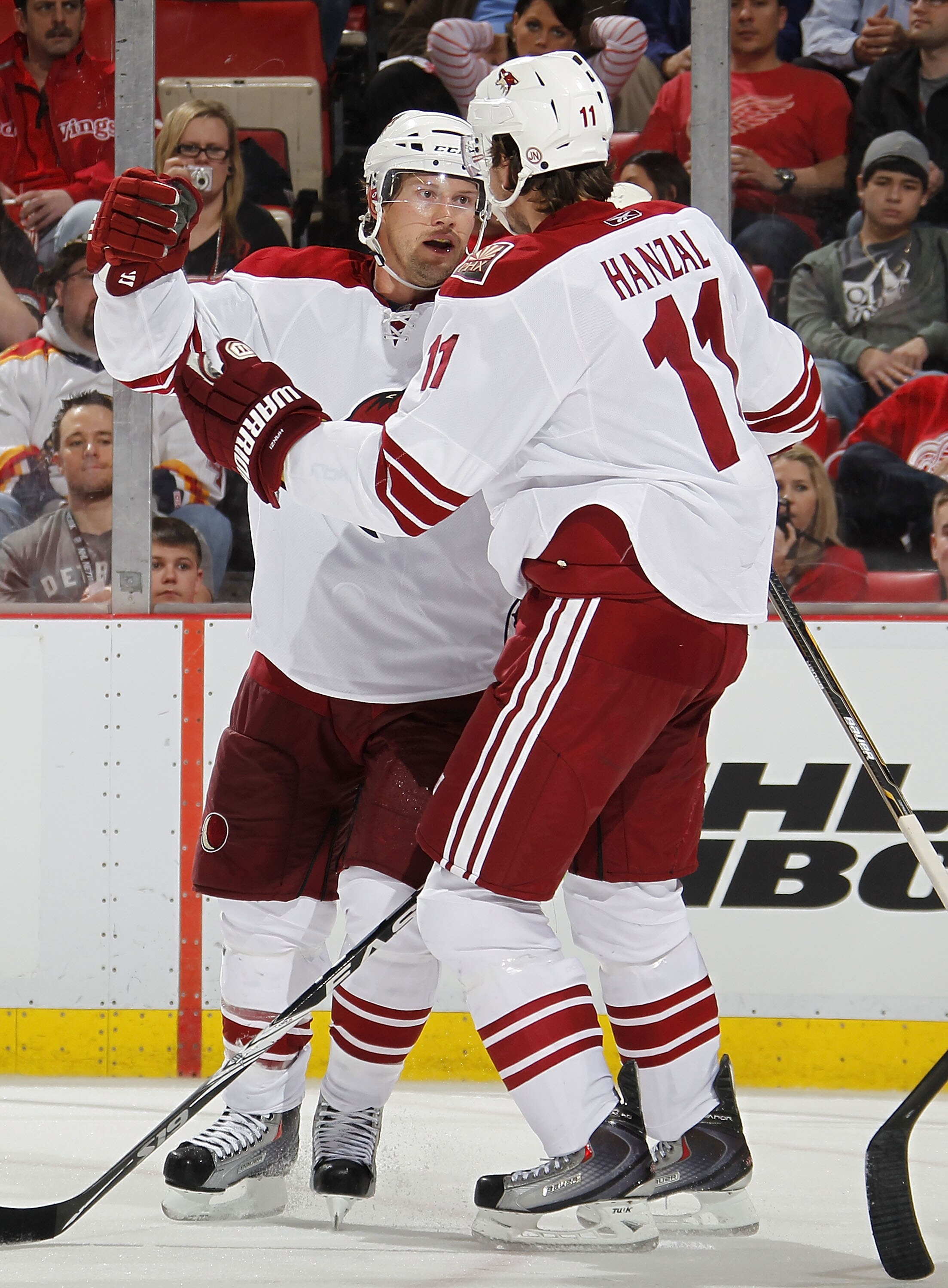 DETROIT, MI - APRIL 16:  Shane Doan #19 of the Phoenix Coyotes celebrates a third-period goal with teammates Martin Hanzal #11 while playing the Detroit Red Wings in Game Two of the Western Conference Quarterfinals during the 2011 Stanley Cup Playoffs at