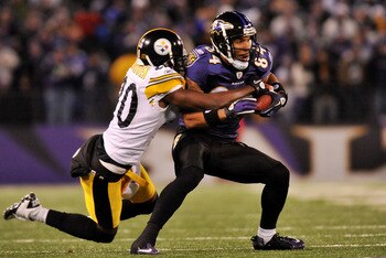 BALTIMORE, MD - DECEMBER 05:  T.J. Houshmandzadeh #84 of the Baltimore Ravens runs the ball against Bryant McFadden #20 of the Pittsburgh Steelers during the first half of the game at M&T Bank Stadium on December 5, 2010 in Baltimore, Maryland. Pittsburgh