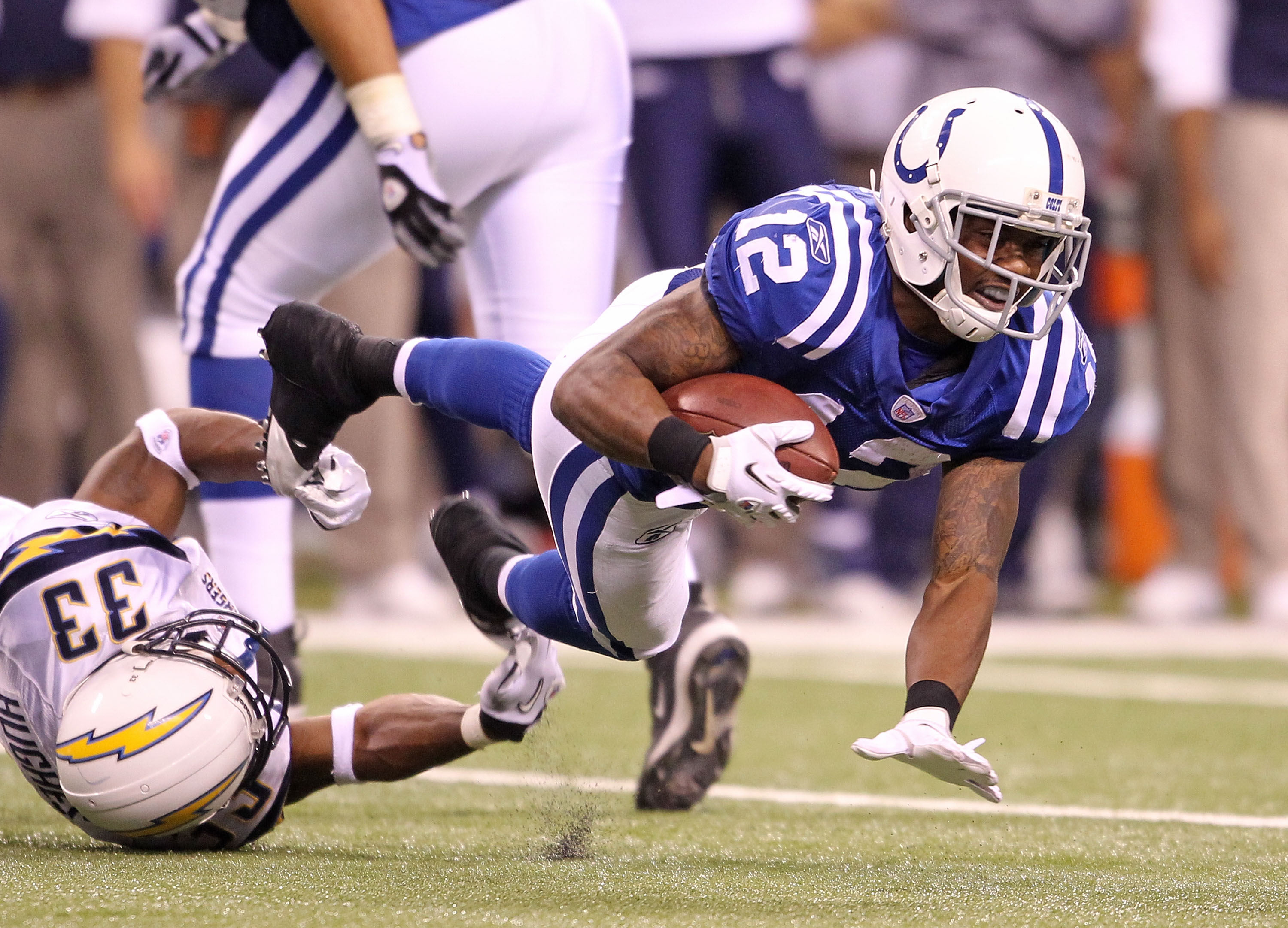 INDIANAPOLIS - NOVEMBER 28:  Brandon James #12 of the Indianapolis Colts is tackled by Dante Hughes #33 of the San Diego Chargers during the NFL game at Lucas Oil Stadium on November 28, 2010 in Indianapolis, Indiana.  (Photo by Andy Lyons/Getty Images)