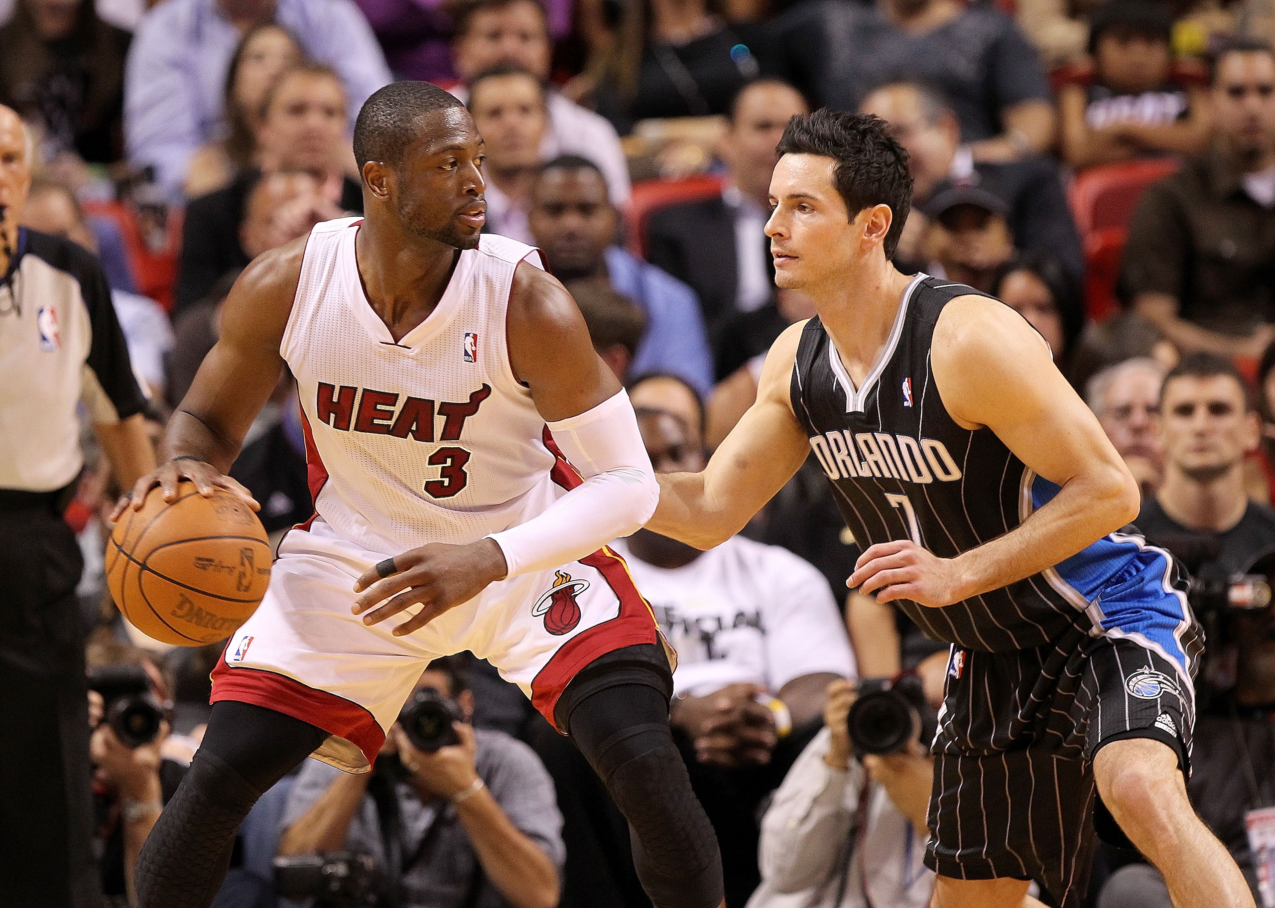 MIAMI, FL - MARCH 03: Dwyane Wade #3 of the Miami Heat posts up J.J. Redick #7 of the Orlando Magic during a game at American Airlines Arena on March 3, 2011 in Miami, Florida. NOTE TO USER: User expressly acknowledges and agrees that, by downloading and/