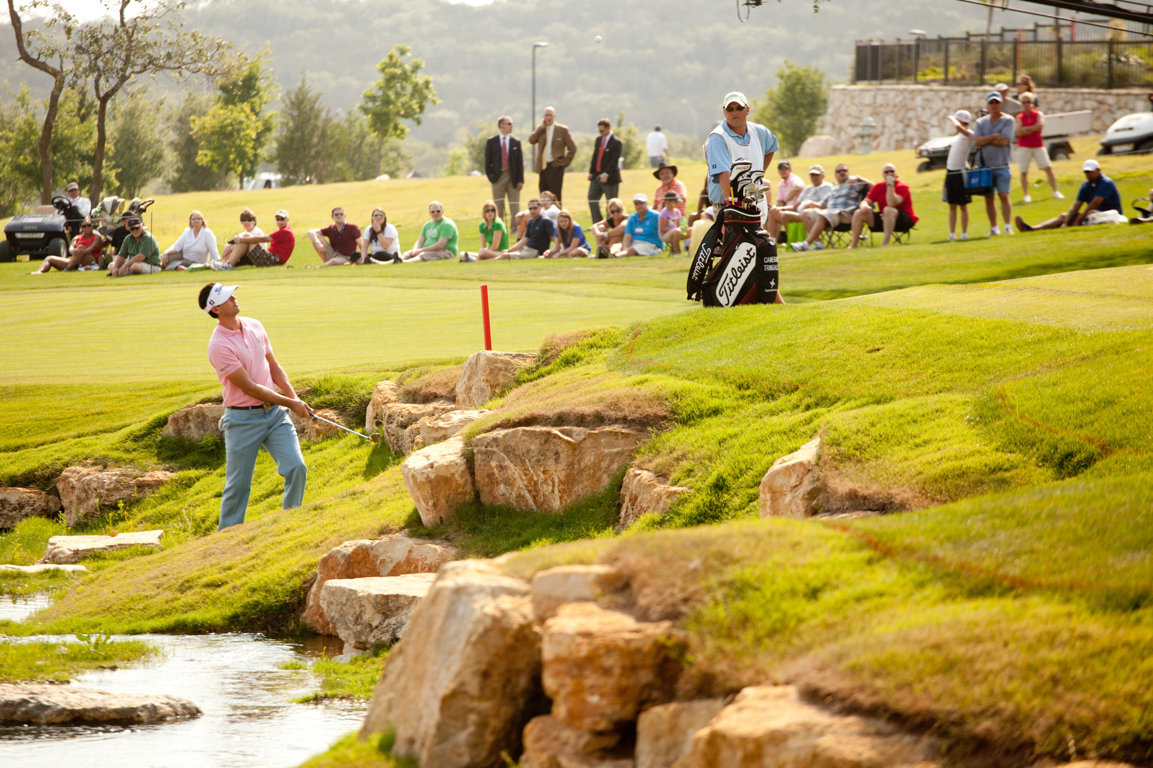 SAN ANTONIO, TX - APRIL 16: Cameron Tringale follows through on a shot from a hazard on the 18th hole during the third round of the Valero Texas Open at the AT&T Oaks Course at TPC San Antonio on April 16, 2011 in San Antonio, Texas. (Photo by Darren Carr