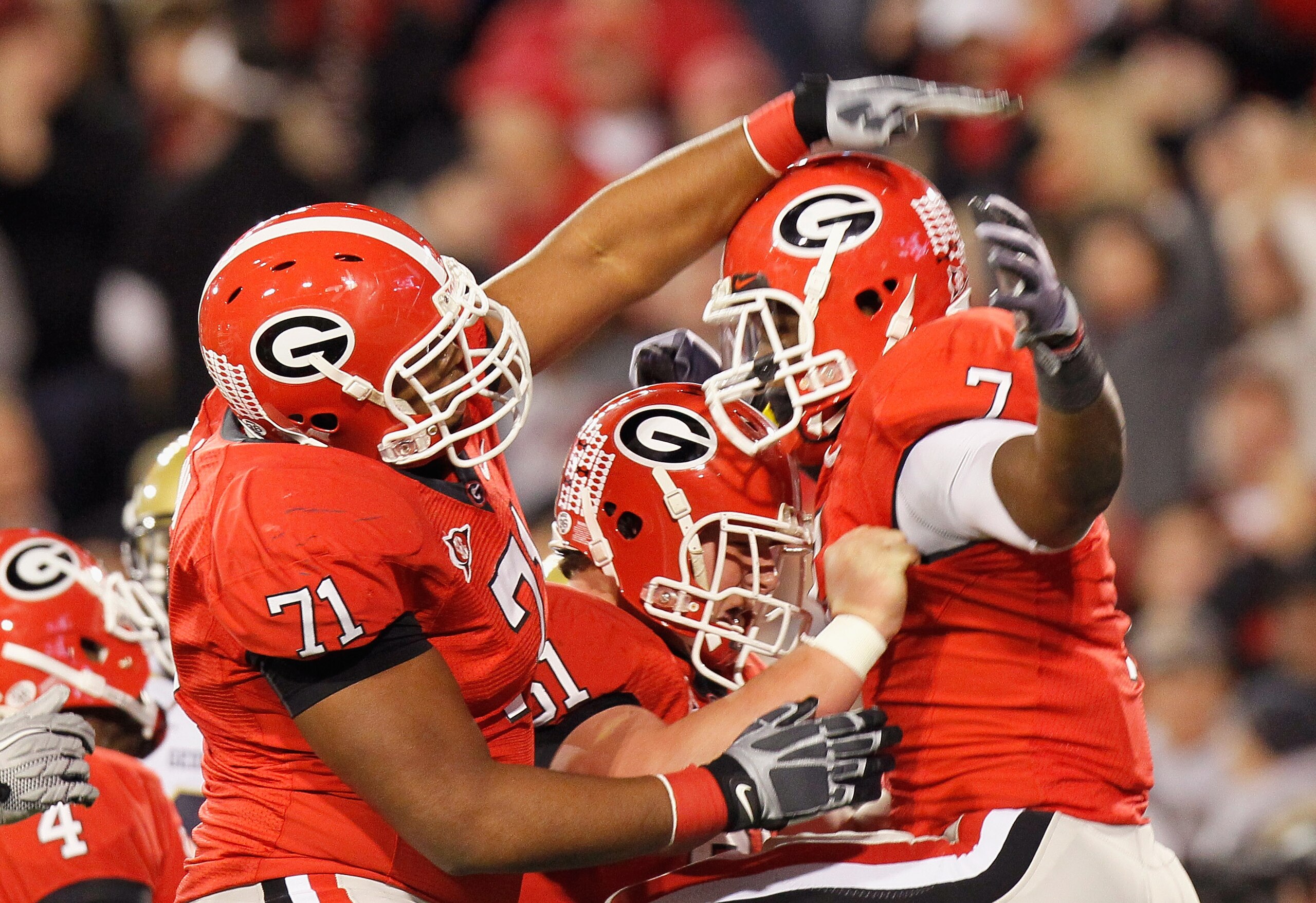 ATHENS, GA - NOVEMBER 27: Cordy Glenn #71 and Ben Jones #61 of the Georgia Bulldogs celebrate with Orson Charles #7 after Charles touchdown against the Georgia Tech Yellow Jackets at Sanford Stadium on November 27, 2010 in Athens, Georgia. (Photo by Kev ATHENS, GA - NOVEMBER 27: Cordy Glenn #71 and Ben Jones #61 of the Georgia Bulldogs celebrate with Orson Charles #7 after Charles touchdown against the Georgia Tech Yellow Jackets at Sanford Stadium on November 27, 2010 in Athens, Georgia. (Photo by Kev