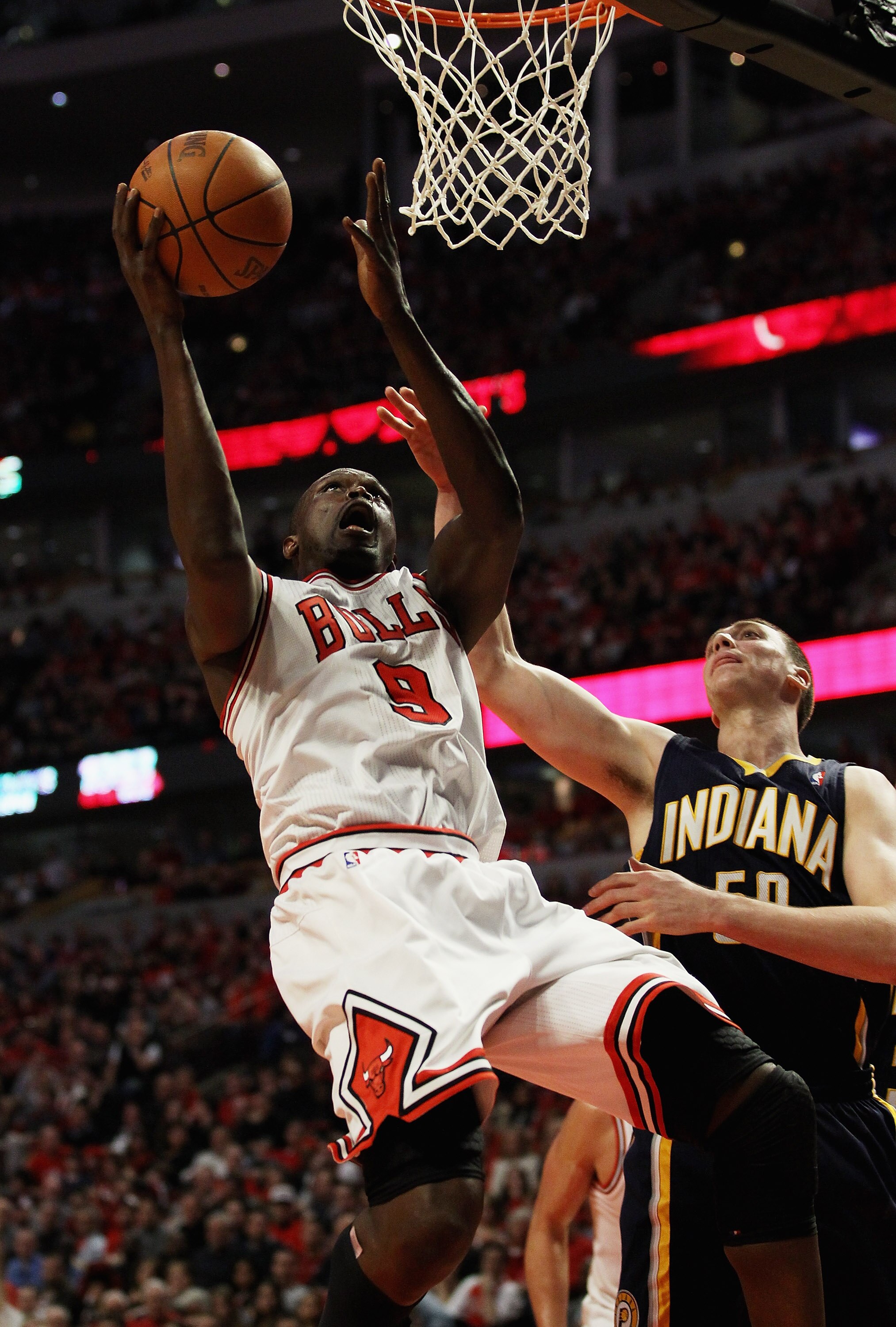 CHICAGO, IL - APRIL 16: Loul Deng #9 of the Chicago Bulls puts up a shot over Tyler Hansbrough #50 of the Indiana Pacers in Game One of the Eastern Conference Quarterfinals in the 2011 NBA Playoffs at the United Center on April 16, 2011 in Chicago, Illino