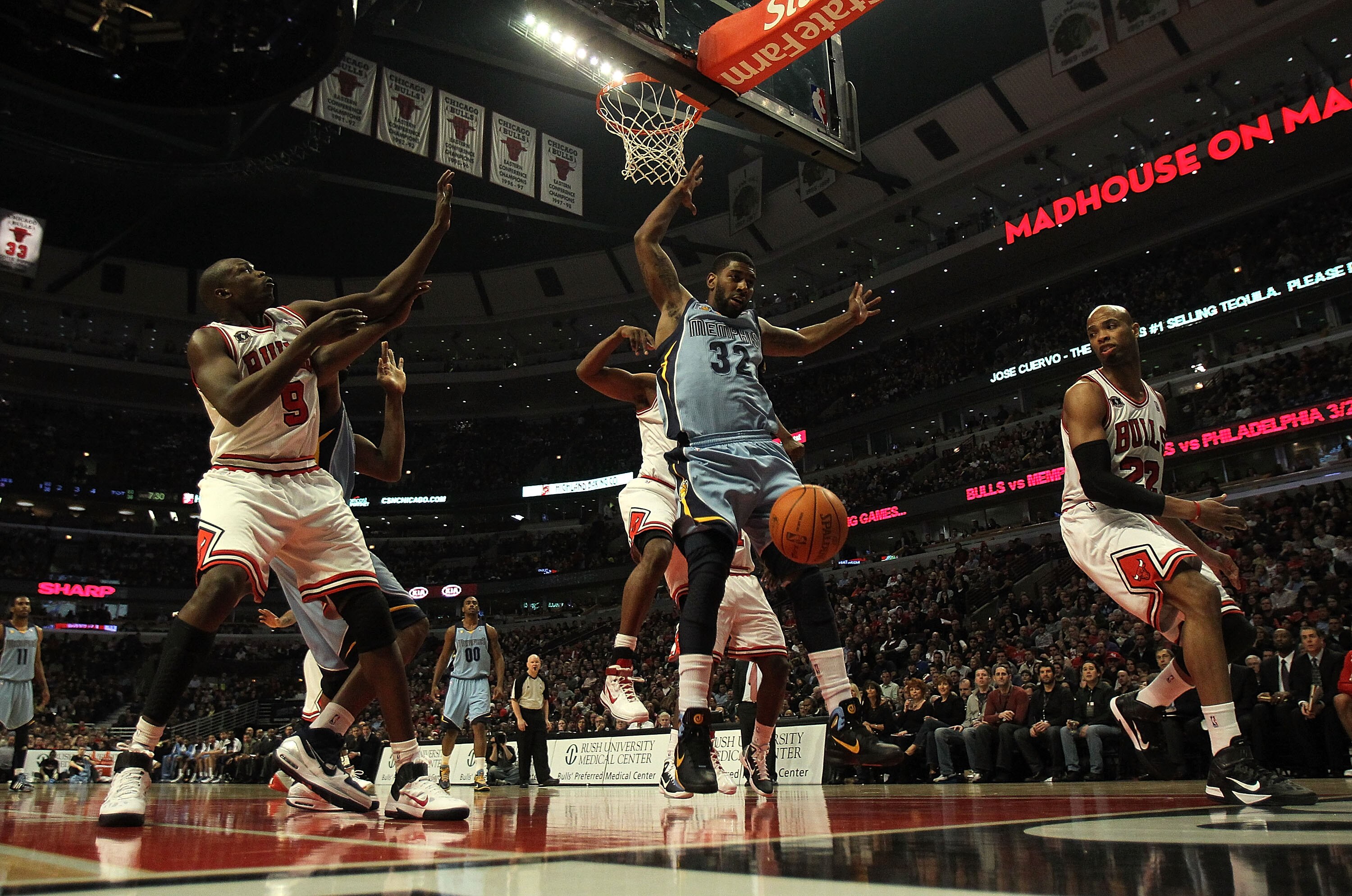 CHICAGO, IL - MARCH 25: O.J. Mayo #32 of the Memphis Grizzlies looses control of the ball under pressure from Kurt Thomas #40 of the Chicago Bulls as Loul Deng #9 (L) and Taj Gibson #22 defend at the United Center on March 25, 2011 in Chicago, Illinois. T