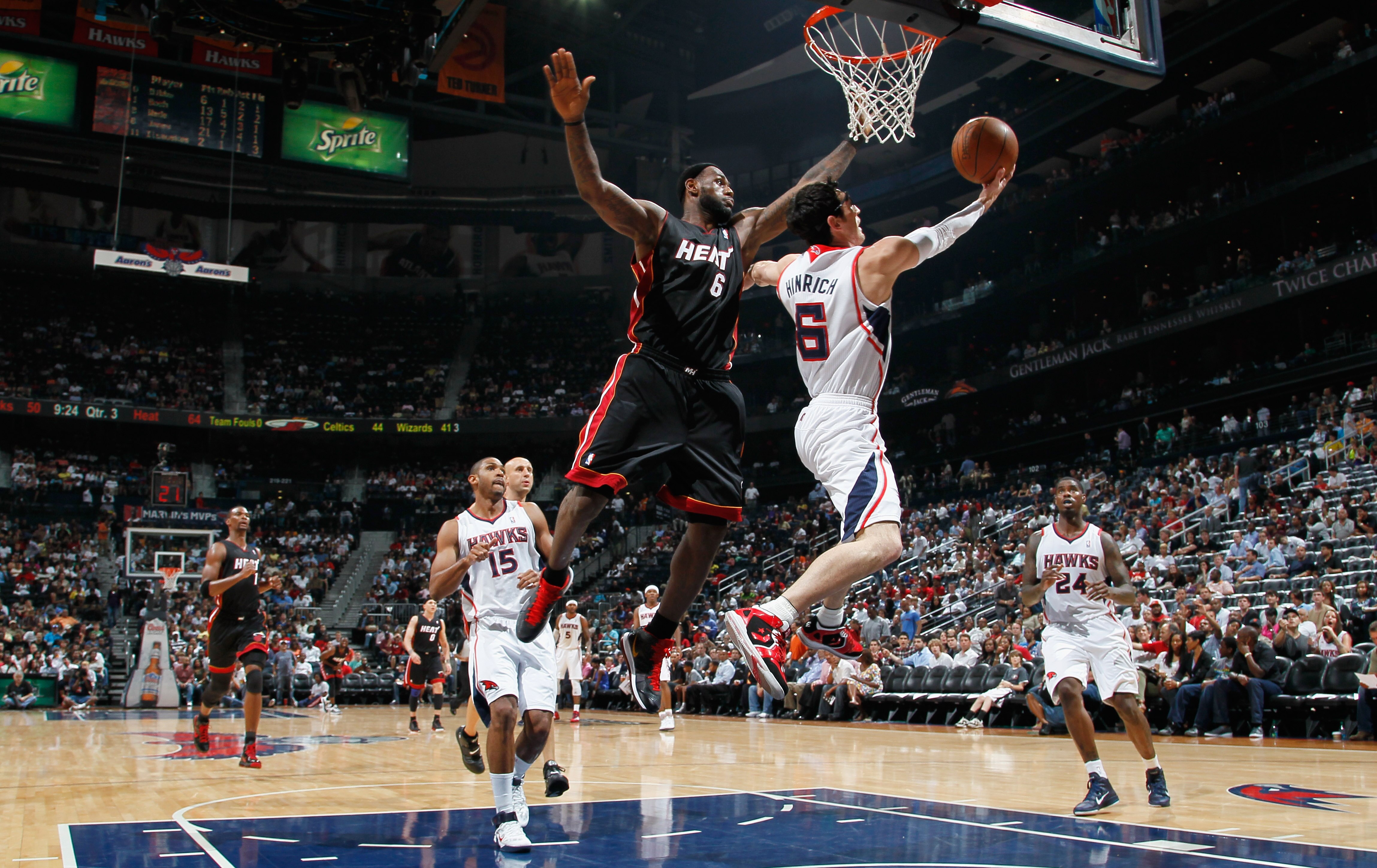 ATLANTA, GA - APRIL 11:  Kirk Hinrich #6 of the Atlanta Hawks lays in a basket against LeBron James #6 of the Miami Heat at Philips Arena on April 11, 2011 in Atlanta, Georgia.  NOTE TO USER: User expressly acknowledges and agrees that, by downloading and