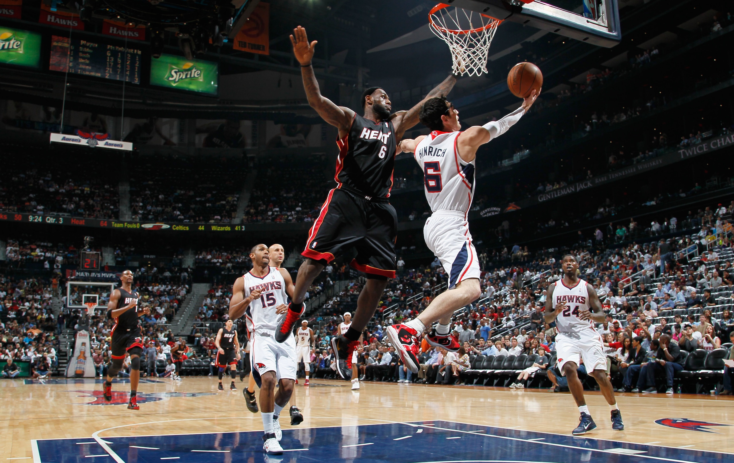 ATLANTA, GA - APRIL 11:  Kirk Hinrich #6 of the Atlanta Hawks lays in a basket against LeBron James #6 of the Miami Heat at Philips Arena on April 11, 2011 in Atlanta, Georgia.  NOTE TO USER: User expressly acknowledges and agrees that, by downloading and
