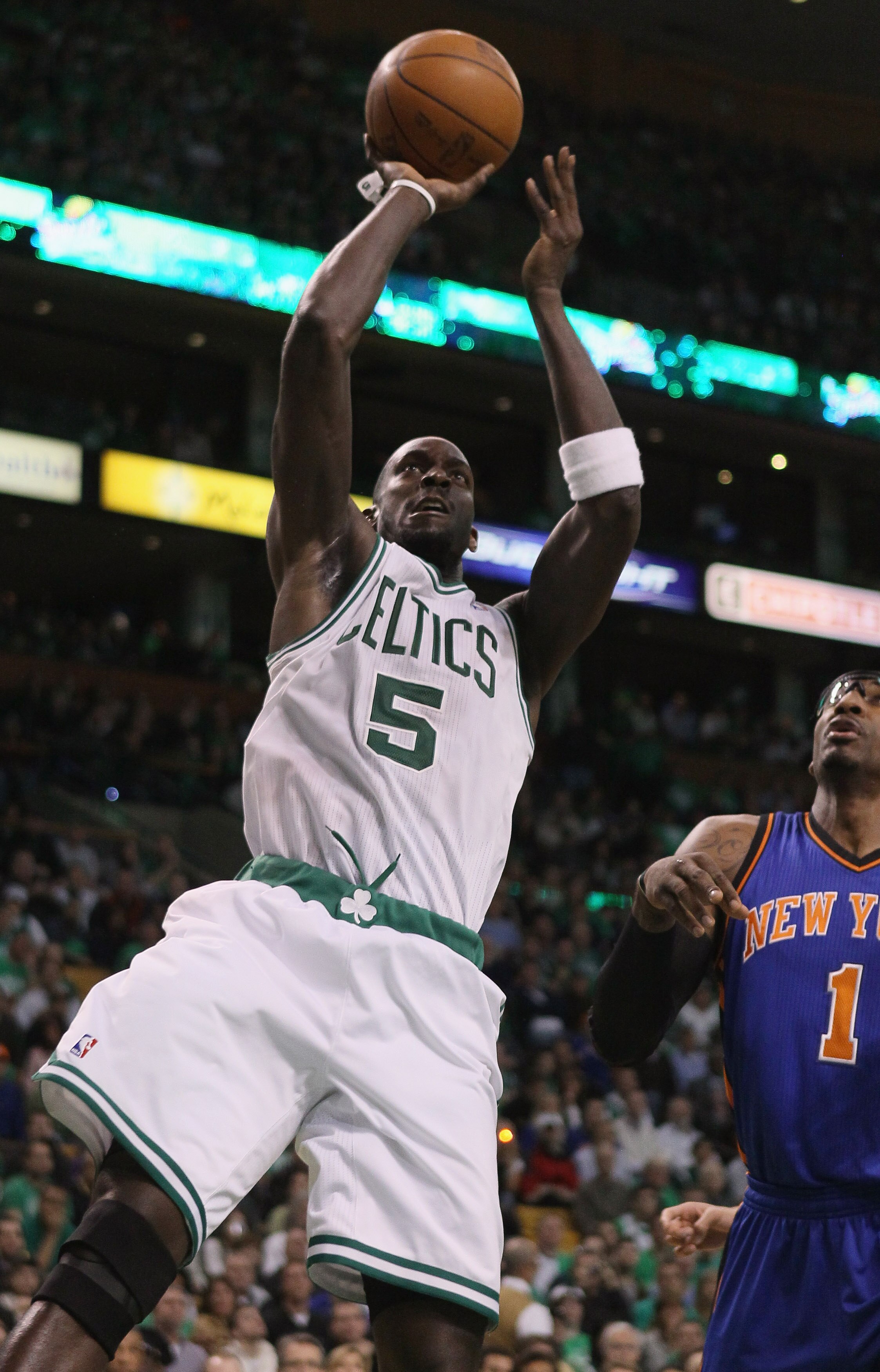 BOSTON, MA - APRIL 17:  Kevin Garnett #5 of the Boston Celtics takes a shot as Amare Stoudemire #1 of the New York Knicks defends in Game One of the Eastern Conference Quarterfinals in the 2011 NBA Playoffs on April 17, 2011 at the TD Garden in Boston, Ma