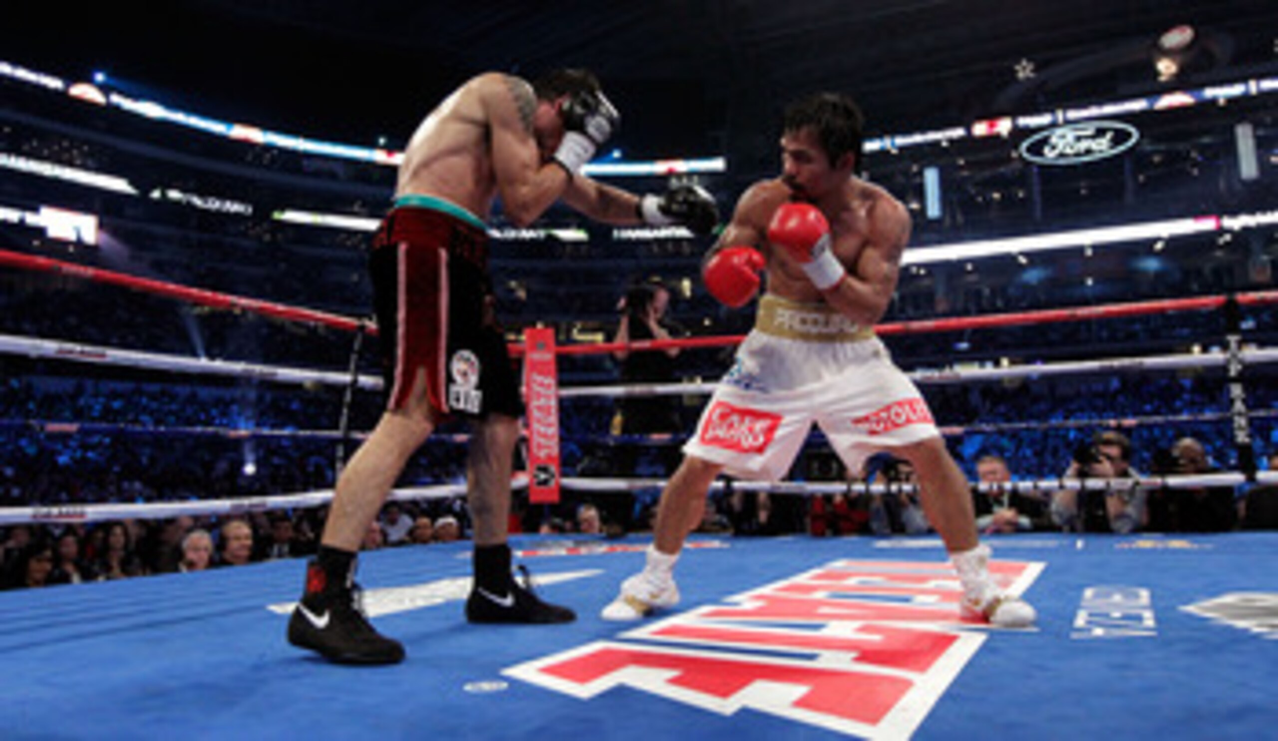 ARLINGTON, TX - NOVEMBER 13:  Manny Pacquiao (white trunks) of the Philippines fights against Antonio Margarito (black trunks) of Mexico during their WBC World Super Welterweight Title bout at Cowboys Stadium on November 13, 2010 in Arlington, Texas.  (Ph