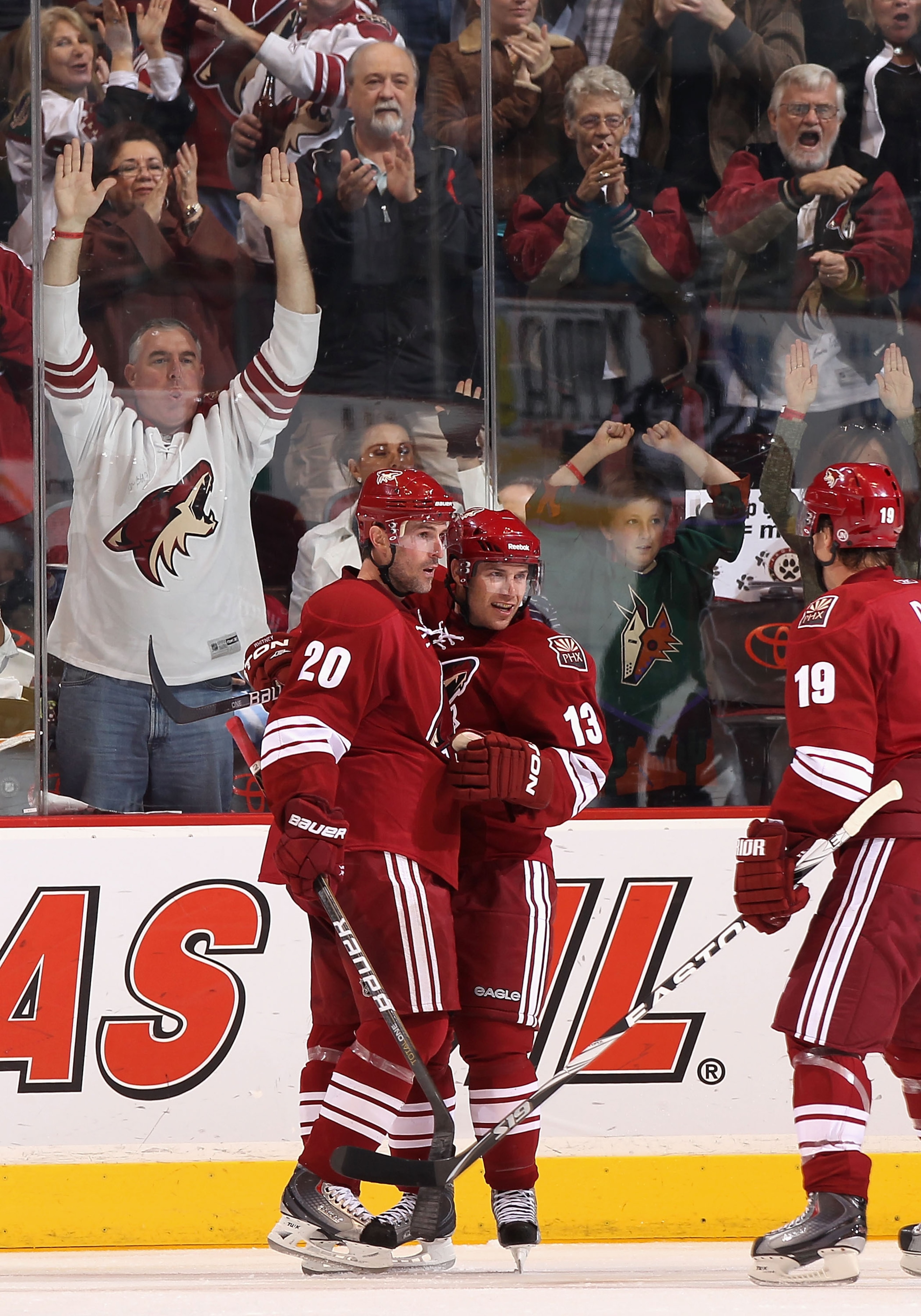 GLENDALE, AZ - APRIL 01:  Ray Whitney #13 of the Phoenix Coyotes celebrates with teammates Eric Belanger #10 and Shane Doan #19 after Whitney scored a third period goal against the Colorado Avalanche during the NHL game at Jobing.com Arena on April 1, 201