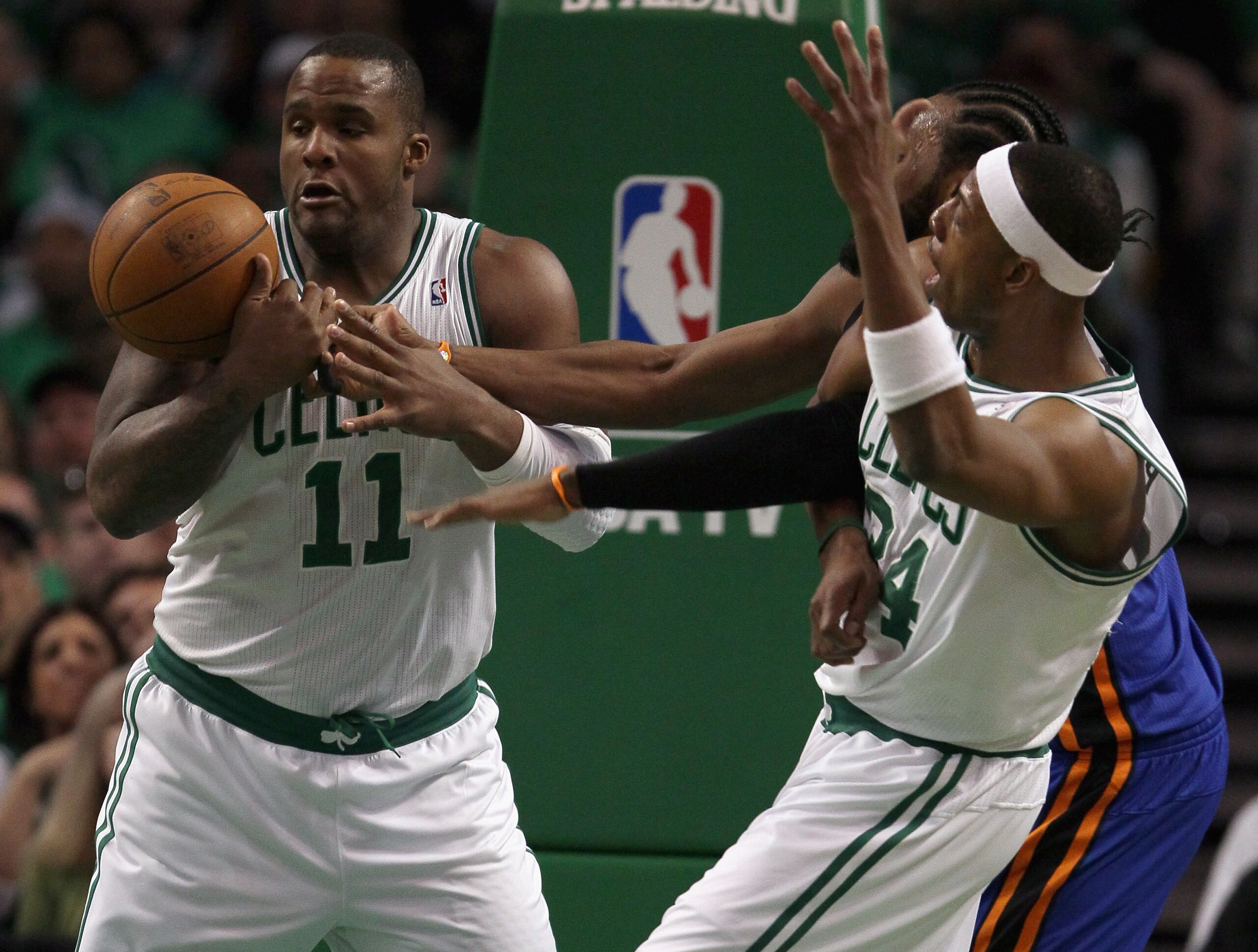 BOSTON, MA - APRIL 17:  Glen Davis #11 of the Boston Celtics tries to hang on to the rebound as teammate Paul Pierce and Ronny Turiaf #14 of the New York Knicks fight for position in Game One of the Eastern Conference Quarterfinals in the 2011 NBA Playoff